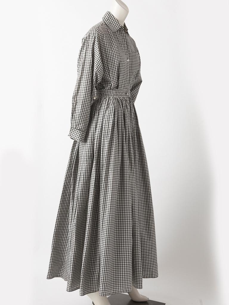 Issac Mizrahi, black and white check, silk taffeta, man tailored, long shirt dress, having a small, pointed collar, pocket detail on the chest, a gathered waist, allowing for a voluminous skirt and rhinestone button closures.