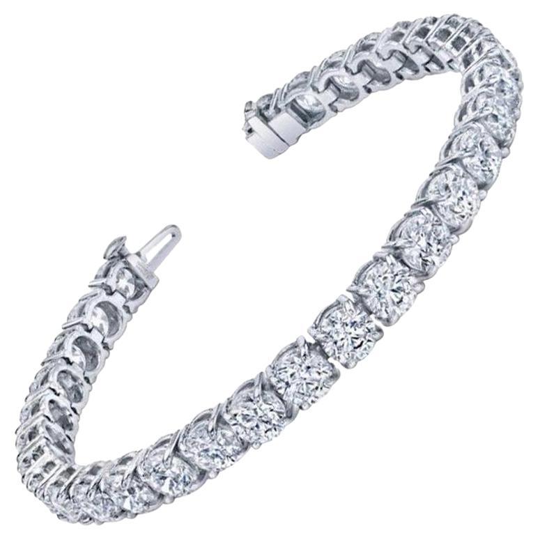Sophisticated elegance. Handcrafted in 18K white gold. 
Set with 39 round ideal cut brilliant Diamonds for a total carat weight of 11.96. 
The Diamonds are near colorless (D-F) and having a clarity of VS/SI. 
We Designed this bracelet as very low