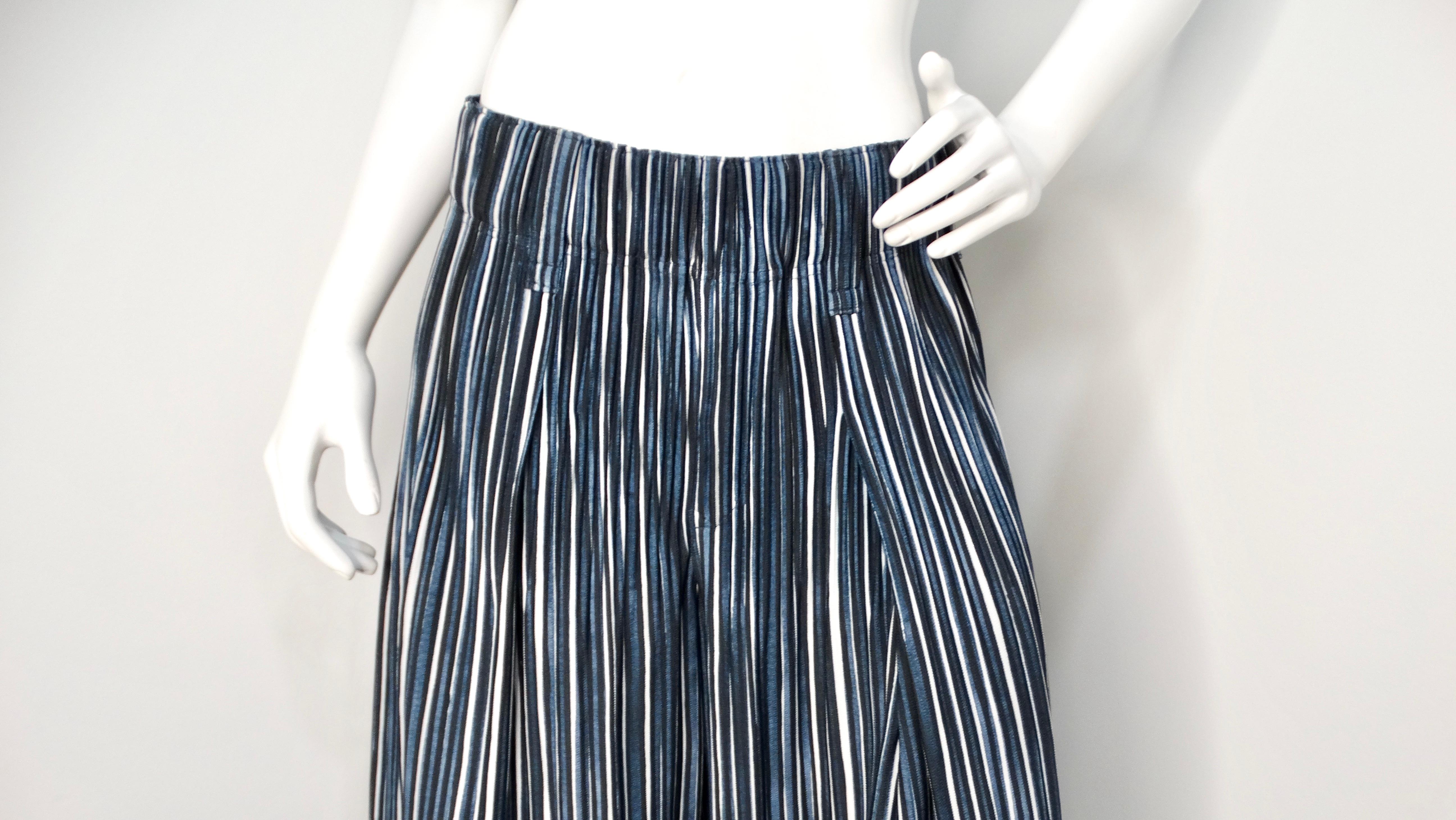 Elevate your wardrobe with the Issey Miyake 1980s Homme Plissé Navy Striped Wide-Leg Pants, an iconic piece that captures the essence of the brand's innovative approach to fashion. These pants feature a striking vertical stripe print in navy,