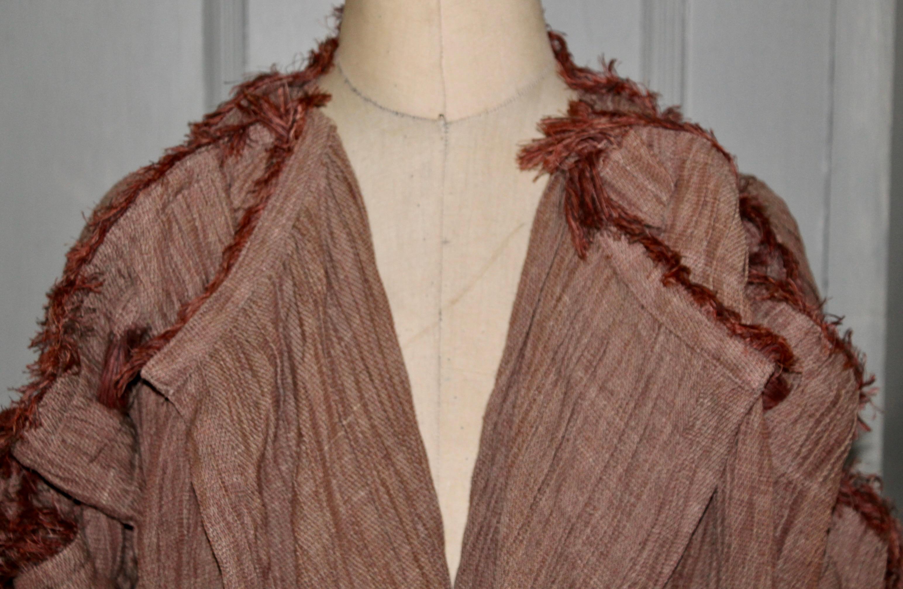 Radical and original, knotted linen sleeves, fringed. This exact item is in NYC's Metropolitan Museum's Costume Institutes Collection. 