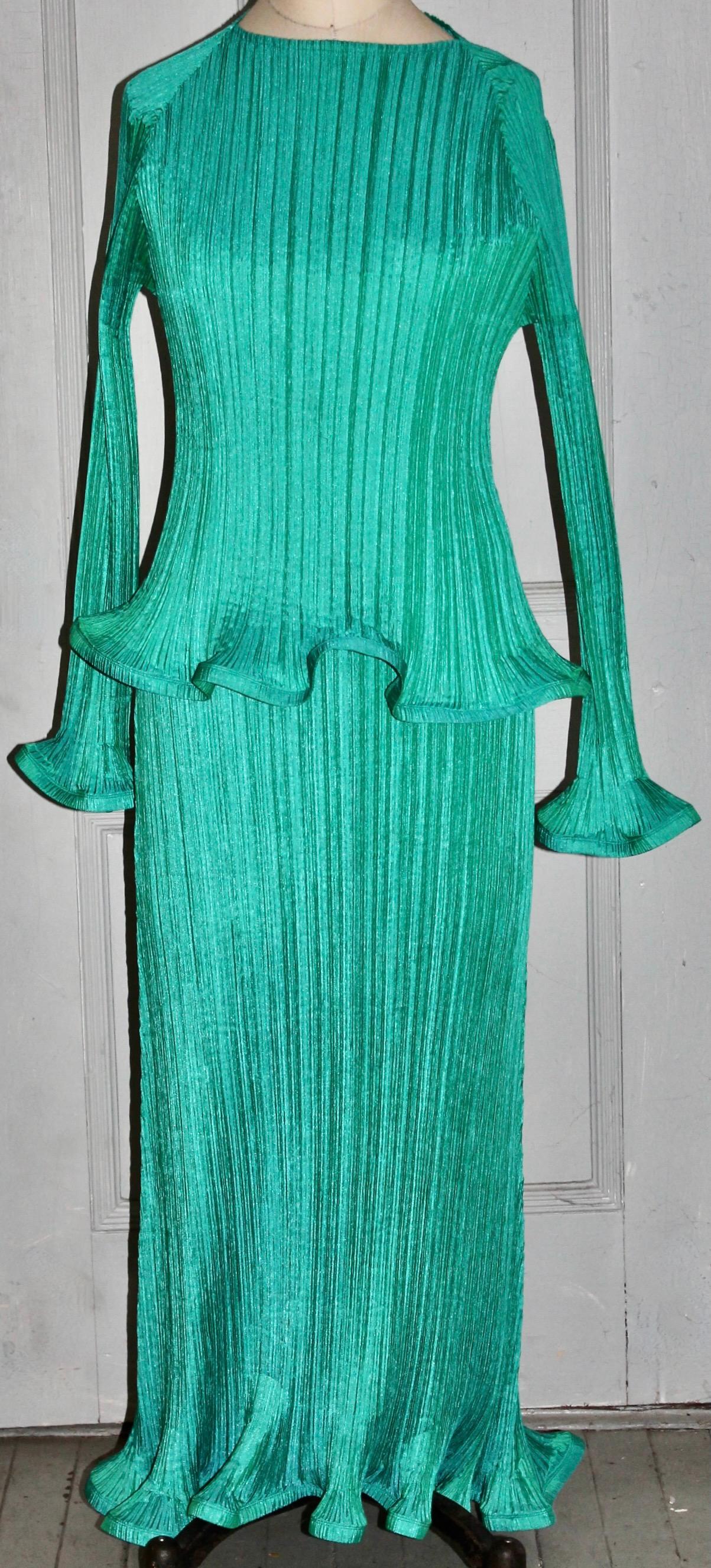 Offering a bright green pleated sculptural Issey Miyake (labeled) Polyester dress
and overtop. Overall length 52