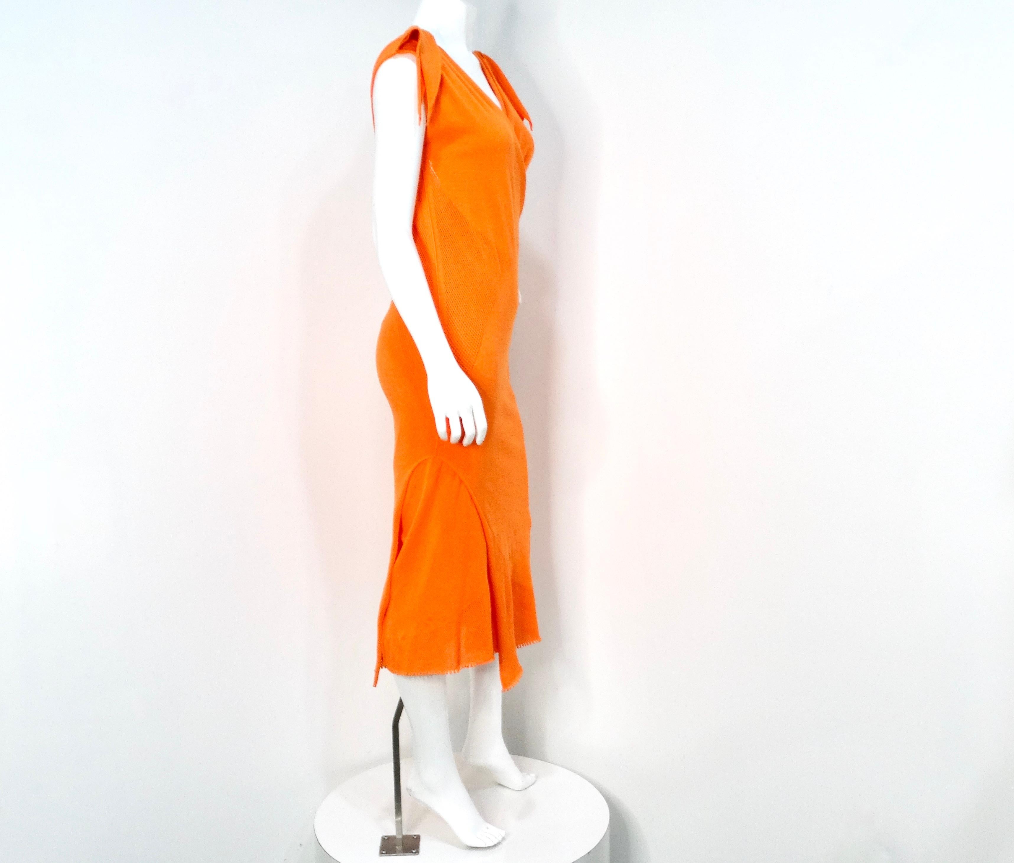 The Issey Miyake 2005 A-POC Orange Two-Piece Dress is a stunning embodiment of the innovative design philosophy that the celebrated designer is known for. This unique ensemble consists of two complementary pieces: an under and outer layer that