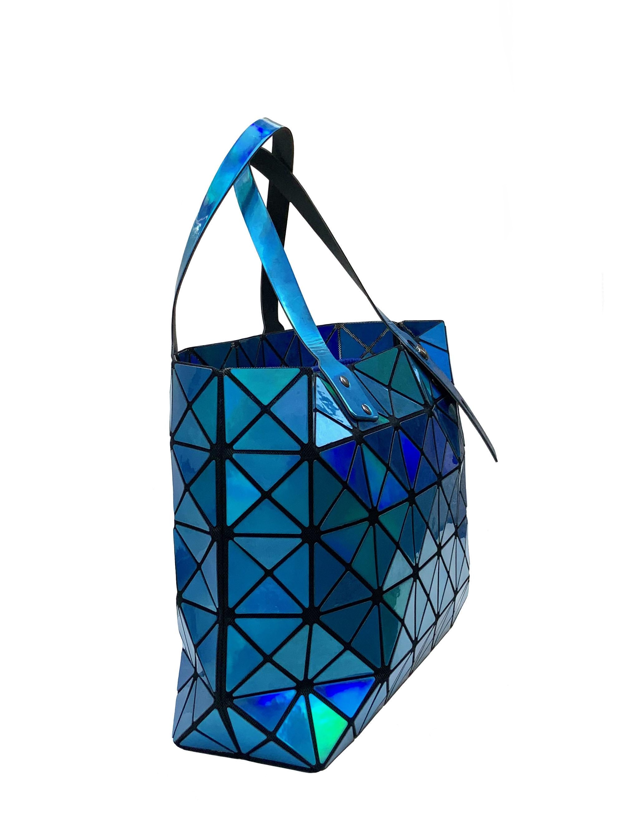 This pre-owned Bao Bao bag from Issey Miyake is a classic signature from the japanese brand. Triangular tiles, inside black mesh, adjustable top handles.

Material: PVC
Lining: Microfiber
Color: Blue
Measurements: 43 cms x 26 cms x 11 cms - Approx.