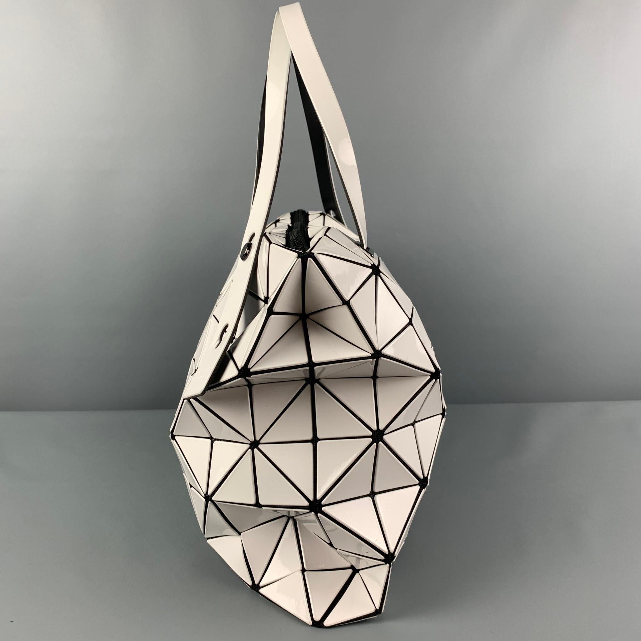 ISSEY MIYAKE BAO BAO bag comes in a white & black leather featuring signature triangular appliqués , mesh tote in black, adjustable top handles, and a inner zipper pocket. Made in Japan.

Very Good Pre-Owned Condition.

Measurements:

Length: 16