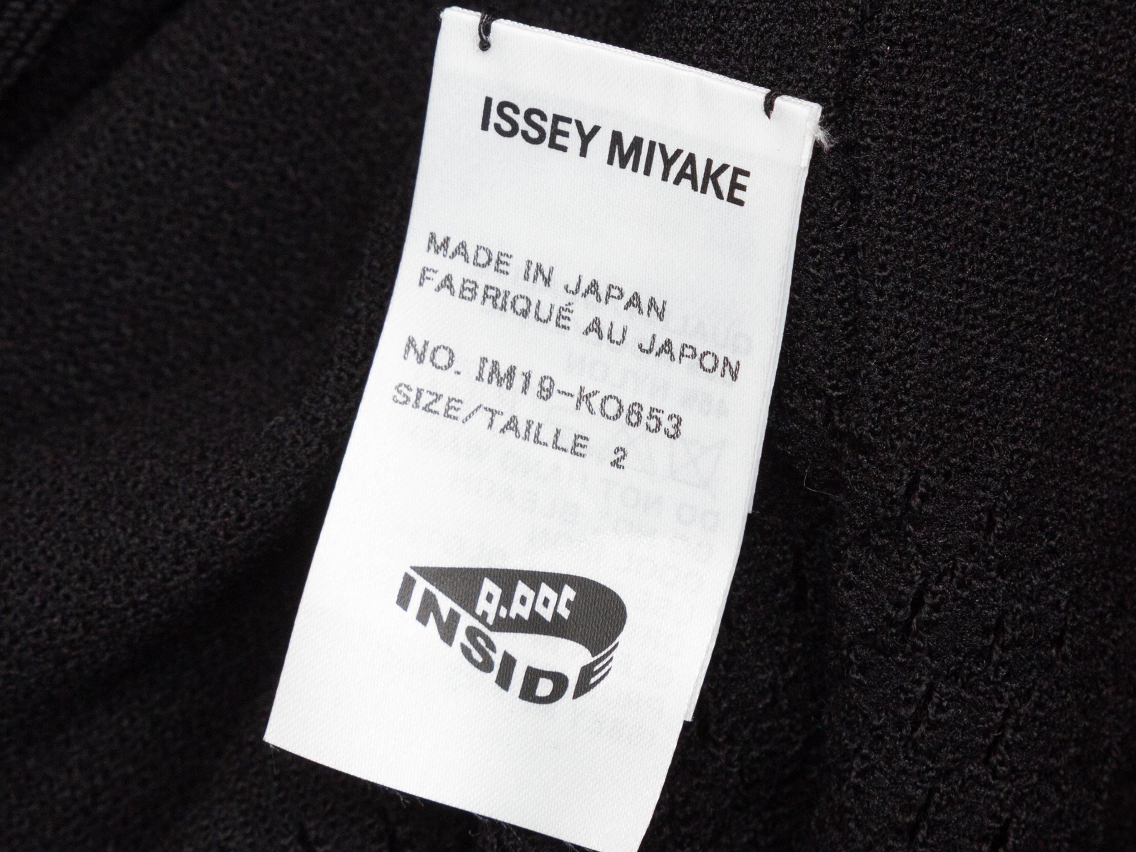 Product details: Black knit short sleeve bolero by Issey Miyake A-POC. Fringe trim throughout. Designer size 2. 38