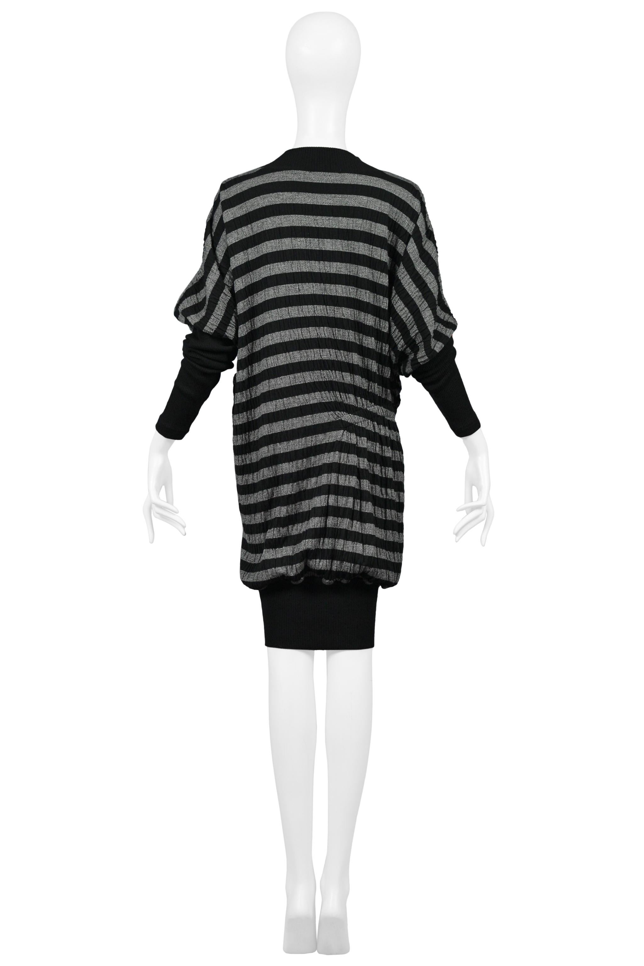 Resurrection Vintage is excited to offer a vintage Issey Miyake black and grey striped dress with asymmetrical smocking, long sleeves with contrasting cuffs, and a knee-length body with contrasting hem. 

Issey Miyake
Size M
Knit
Excellent Vintage