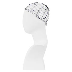 Issey Miyake: retina per capelli nera con perline blu