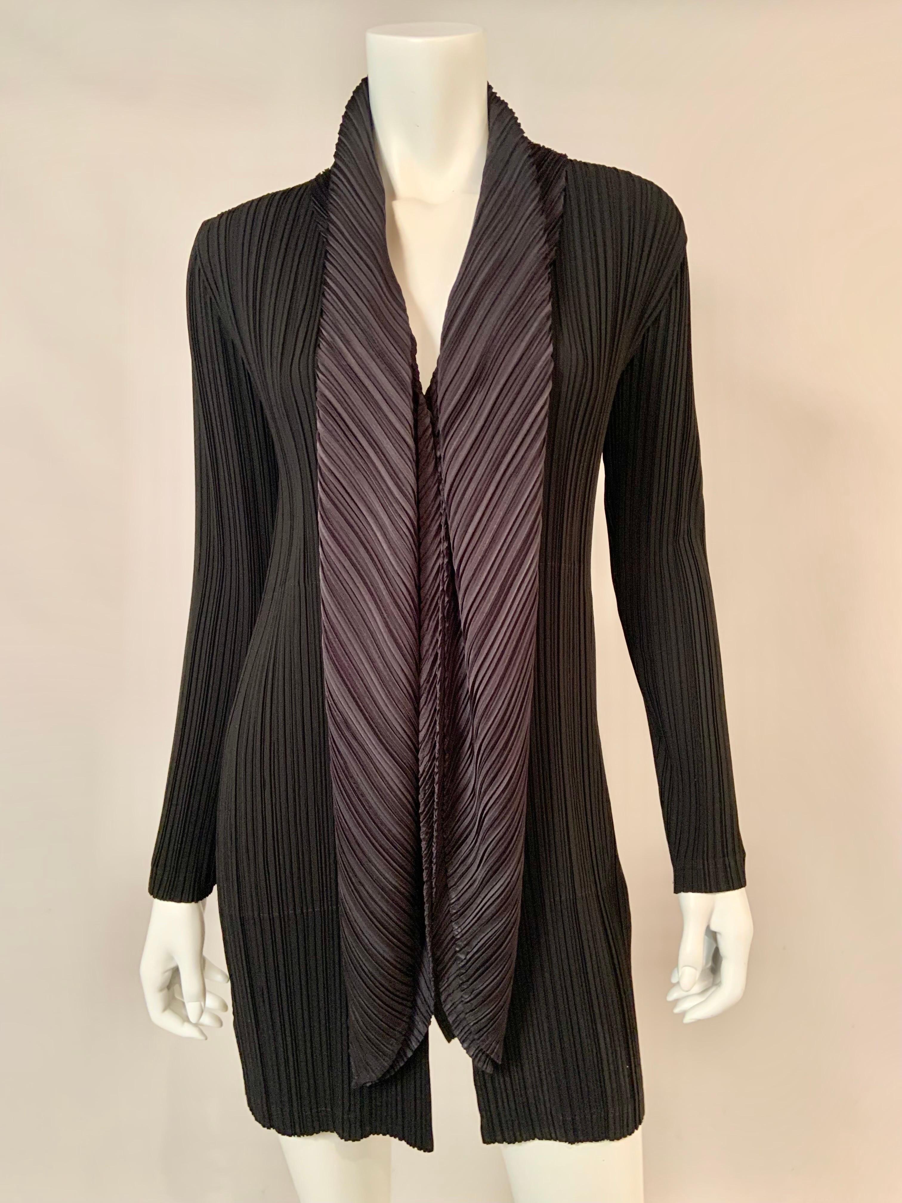A fabulous black pleated coat from Issey Miyake has a three button closure and an attached scarf which can be worn in many ways.  This is effortlessly chic dressing at it's best.  Marked a size 2 or Medium, it is in excellent