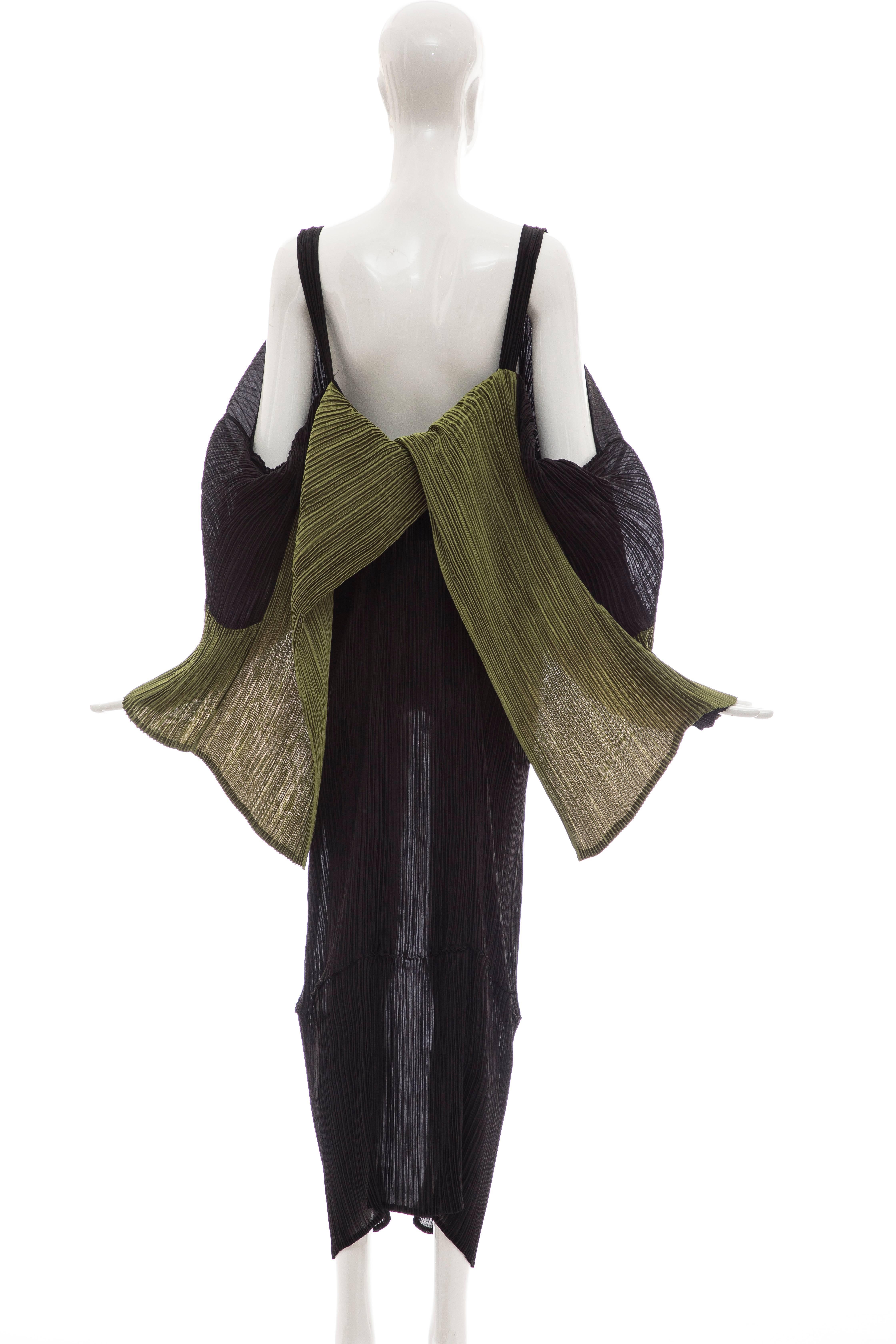 Issey Miyake, Circa 1990's black pleated dress with olive green draped panel at bodice, long sleeves and open back.

Japan: Small

Bust: 36.5, Waist 26, Hip 30, Length 49.5
