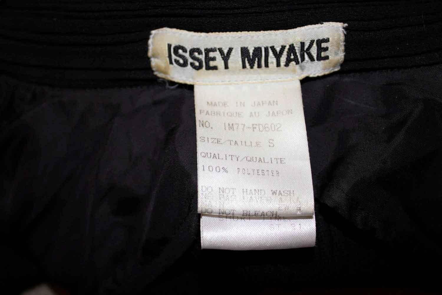 A great jacket by Issey Miyake, main line.. Size S , IM77 FD602.The jacket has a 5 button fastening, with a pocket on either side, with a button on each pocket. It has a black trim on the collar , pockets and hem. Measurements  Bust 37'' - 40'',