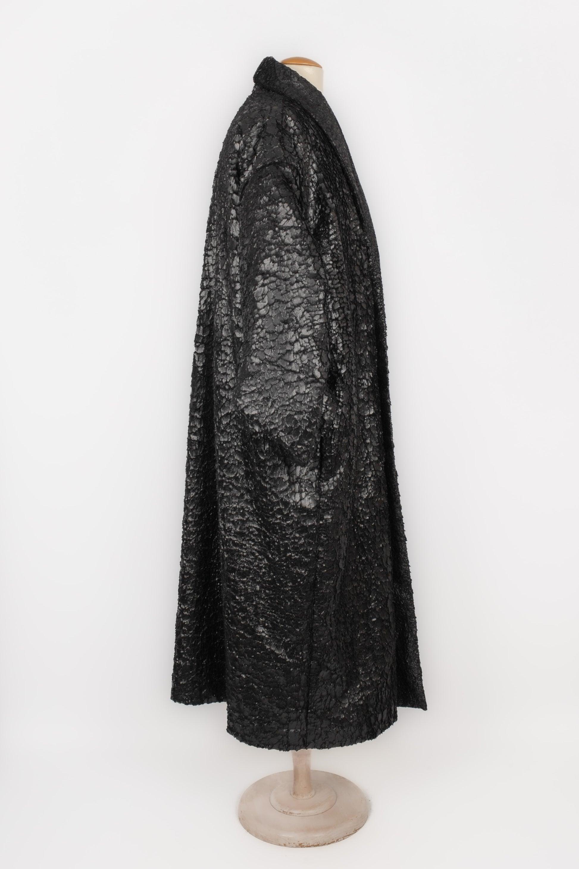 Issey Miyake - (Made in Japan) Black polyester fleece men coat with a heat treatment to melt the fiber ends together in a scale shape. Gathered sleeves and shawl collar. Size M indicated. 1987-1988 Fall-Winter Collection.

Additional
