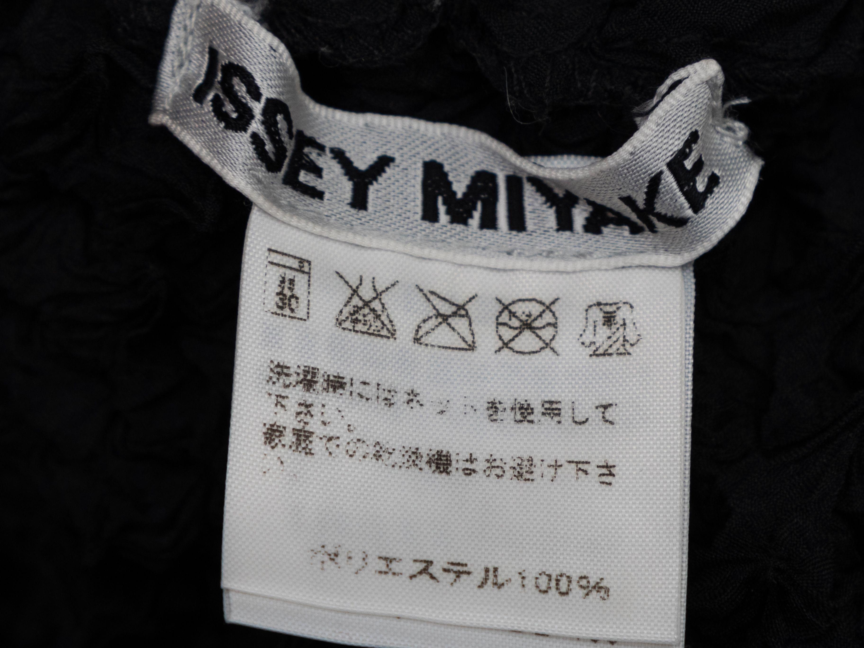Product Details: Black popcorn texture long sleeve top by Issey Miyake. Pointed collar. Button closures at center front. 38