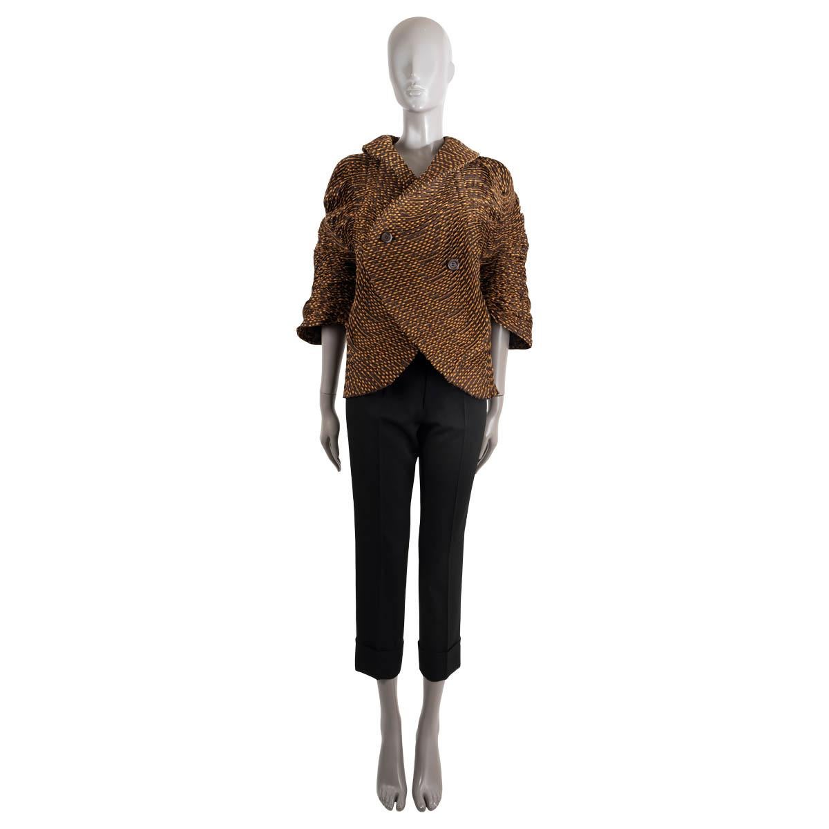100% authentic Issey Miyake 3/4 sleeve shawl collar jacquard blouse in stretchy brown and orange wavey, gathered polyester (80%), cotton (38%) and polyurethane (2%). Button closure. Unlined. Has been worn and is in excellent condition.