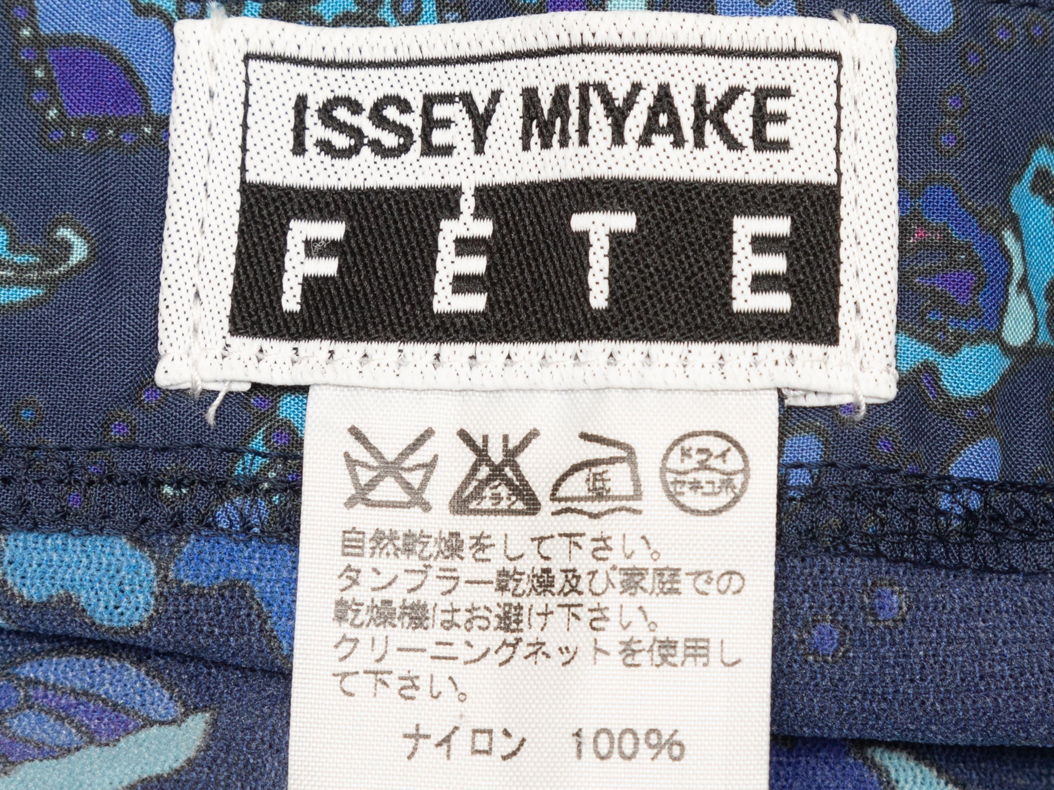 Product Details: Navy and multicolor abstract print skirt by Issey Miyake Fete. Elasticized waistband. Ruffle trim at sides. 28