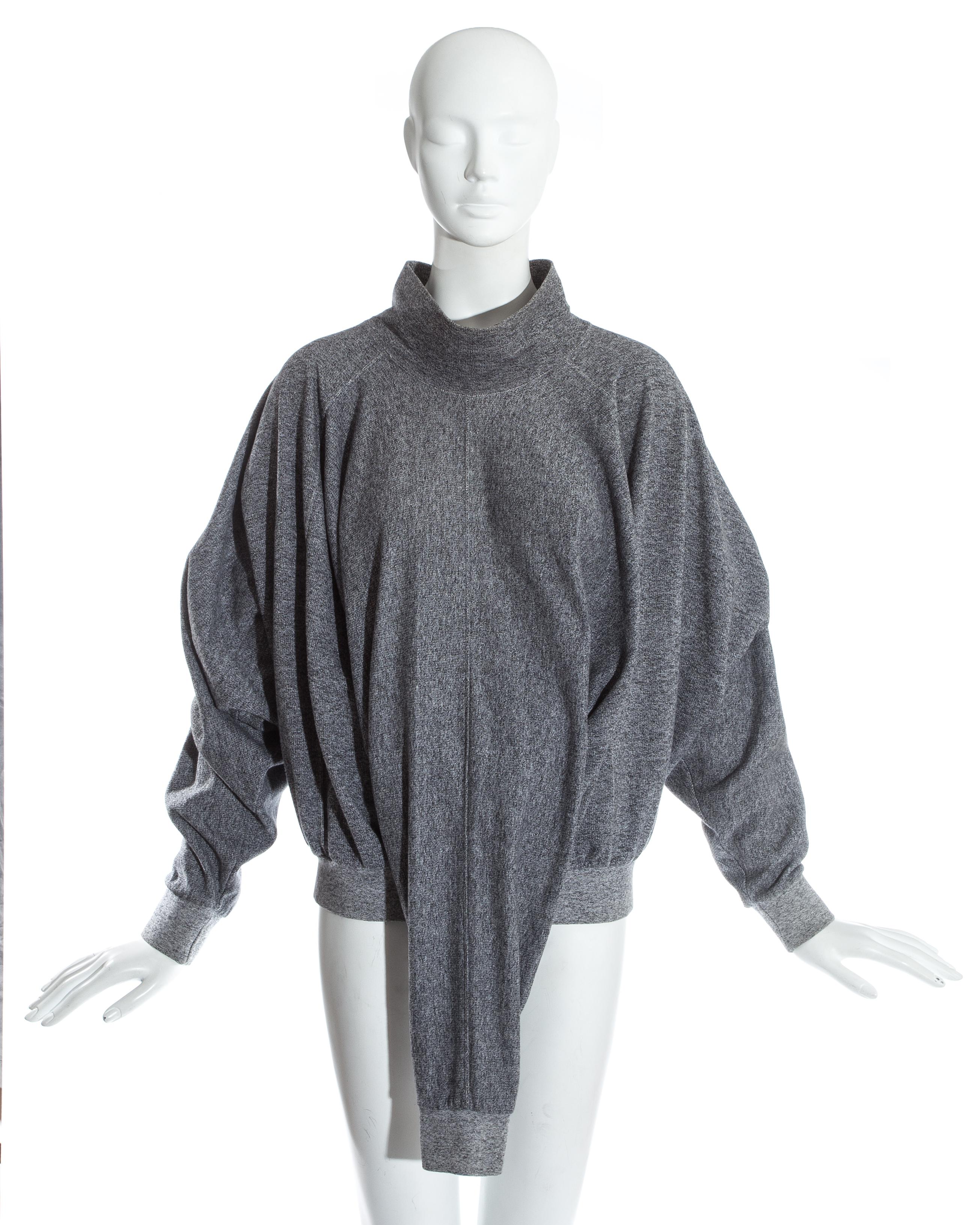 Issey Miyake; Grey knitted turtle neck sweater with three sleeves. The sweater can be styled in various ways. 

'Parts Knit' Fall-Winter 1985
