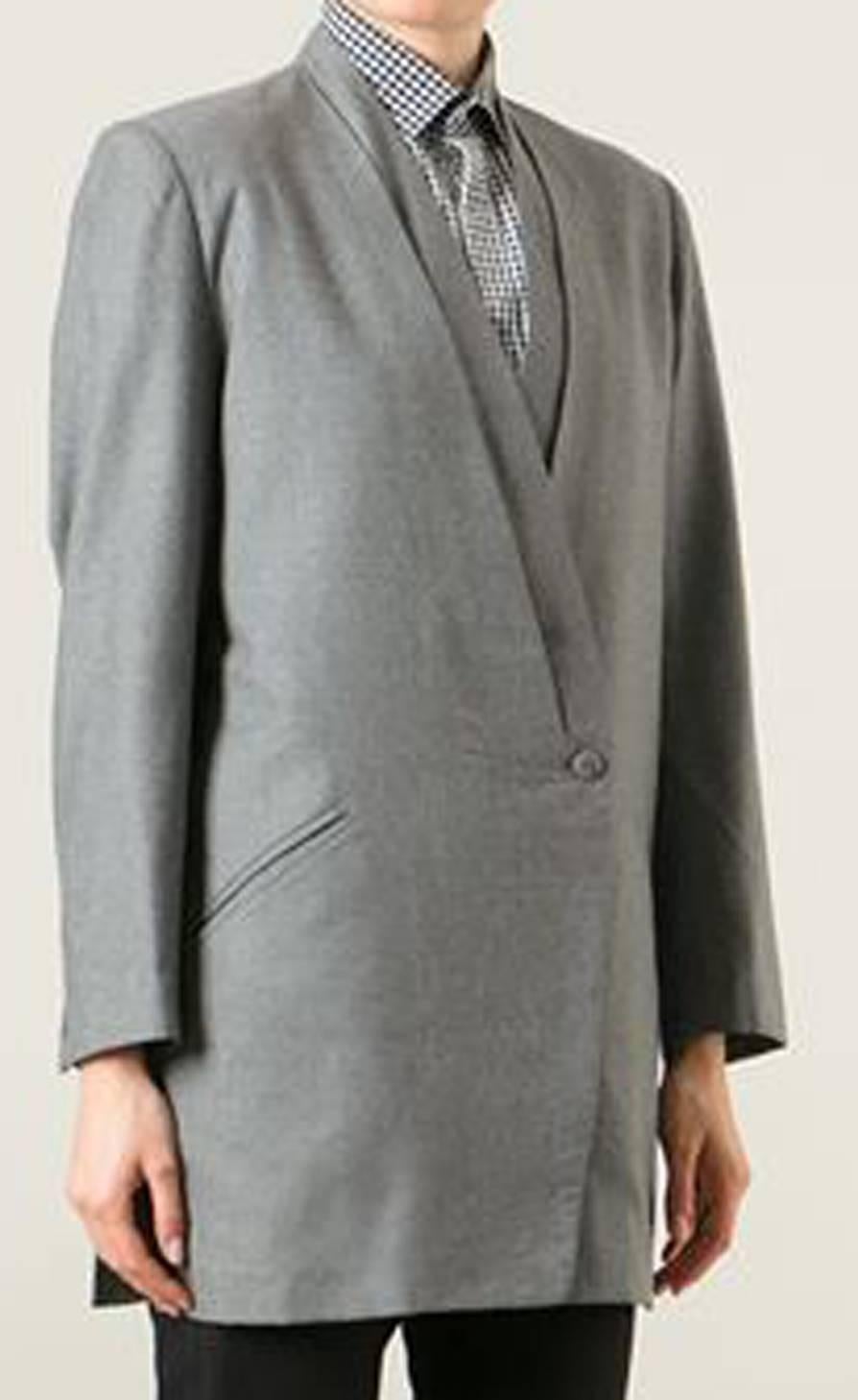 1990s Issey MiyakeGrey wool draped blazer featuring a deep V neck, long sleeves, a front button fastening, two front pockets and side slits. 
In excellent vintage condition. Made in Japan.
Label size: S
We guarantee you will receive this gorgeous