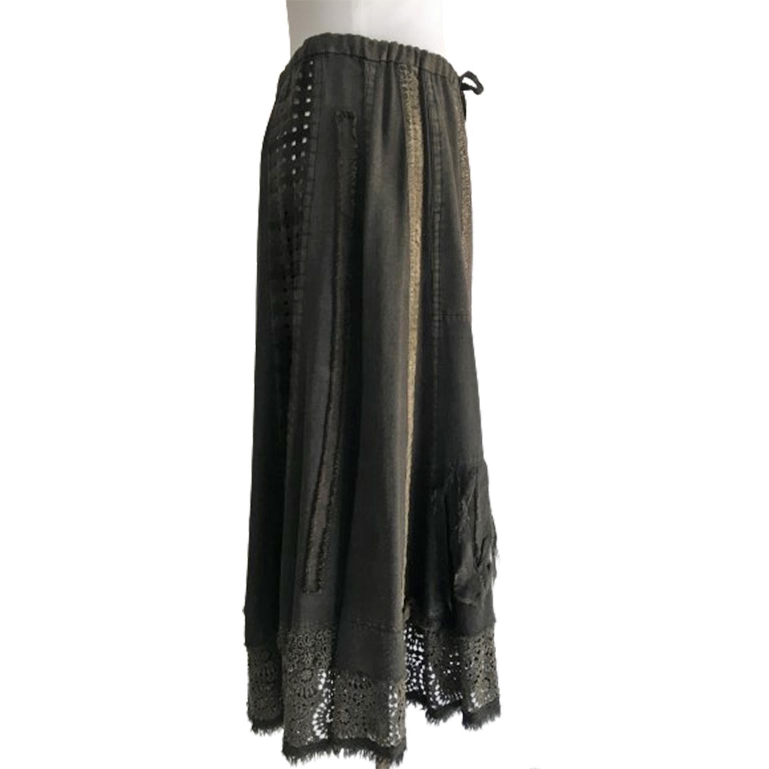 Unique Issey Miyake HaaT skirt from circa 1990s in grey earth tone thin wool. Features different materials in panels. Lace hem. Opens with one string and buttons on the front. Unlined. Incredible mix of textile. Has been worn and is in excellent