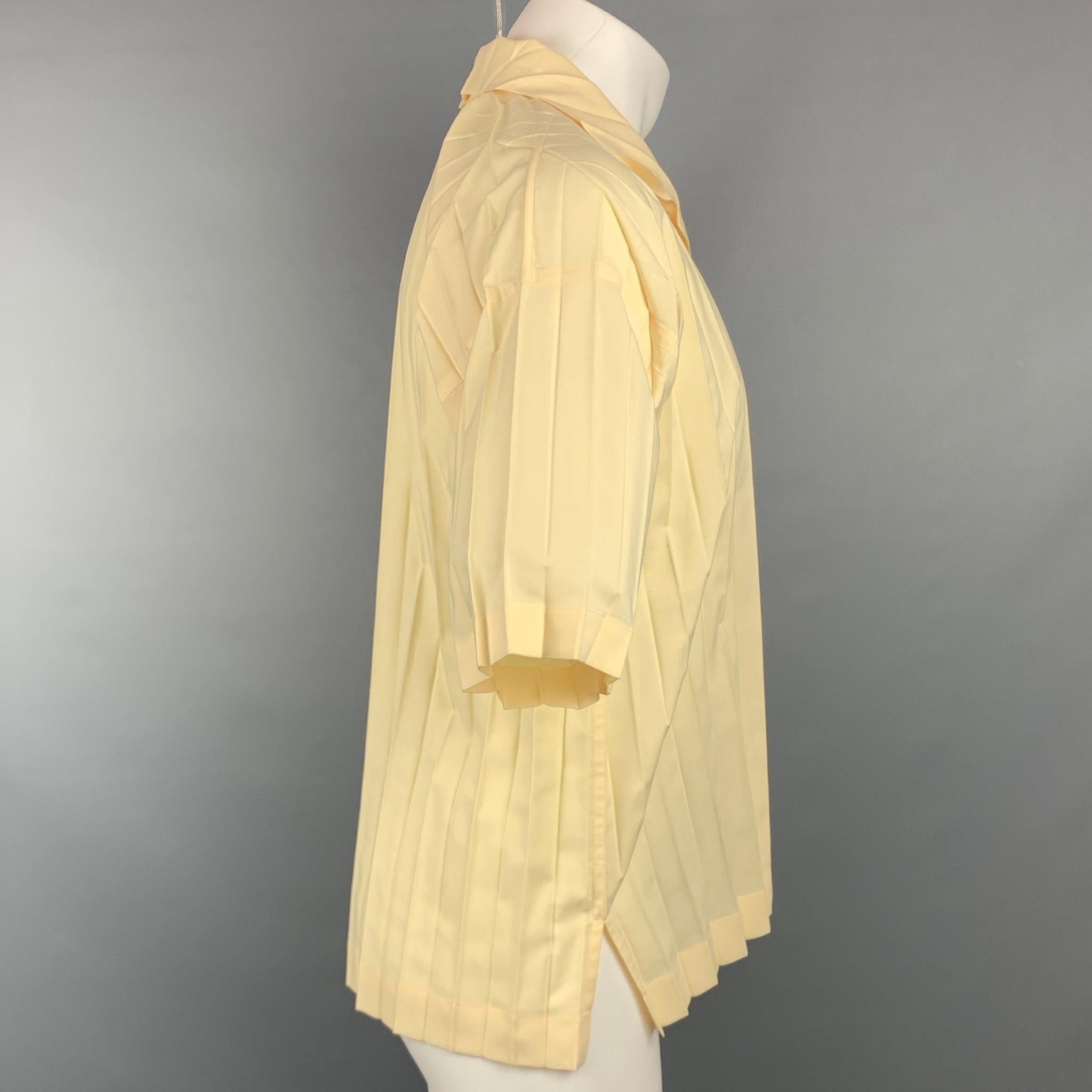 ISSEY MIYAKE HOMME PLISSE short sleeve shirt comes in yellow wrinkled material featuring a button up style and spread collar. Made in Japan.

New With Tags. 
Marked: JP 2

Measurements:

Shoulder: 23.5 in.
Chest: 46 in.
Sleeve: 9 in.
Length: 26 in. 