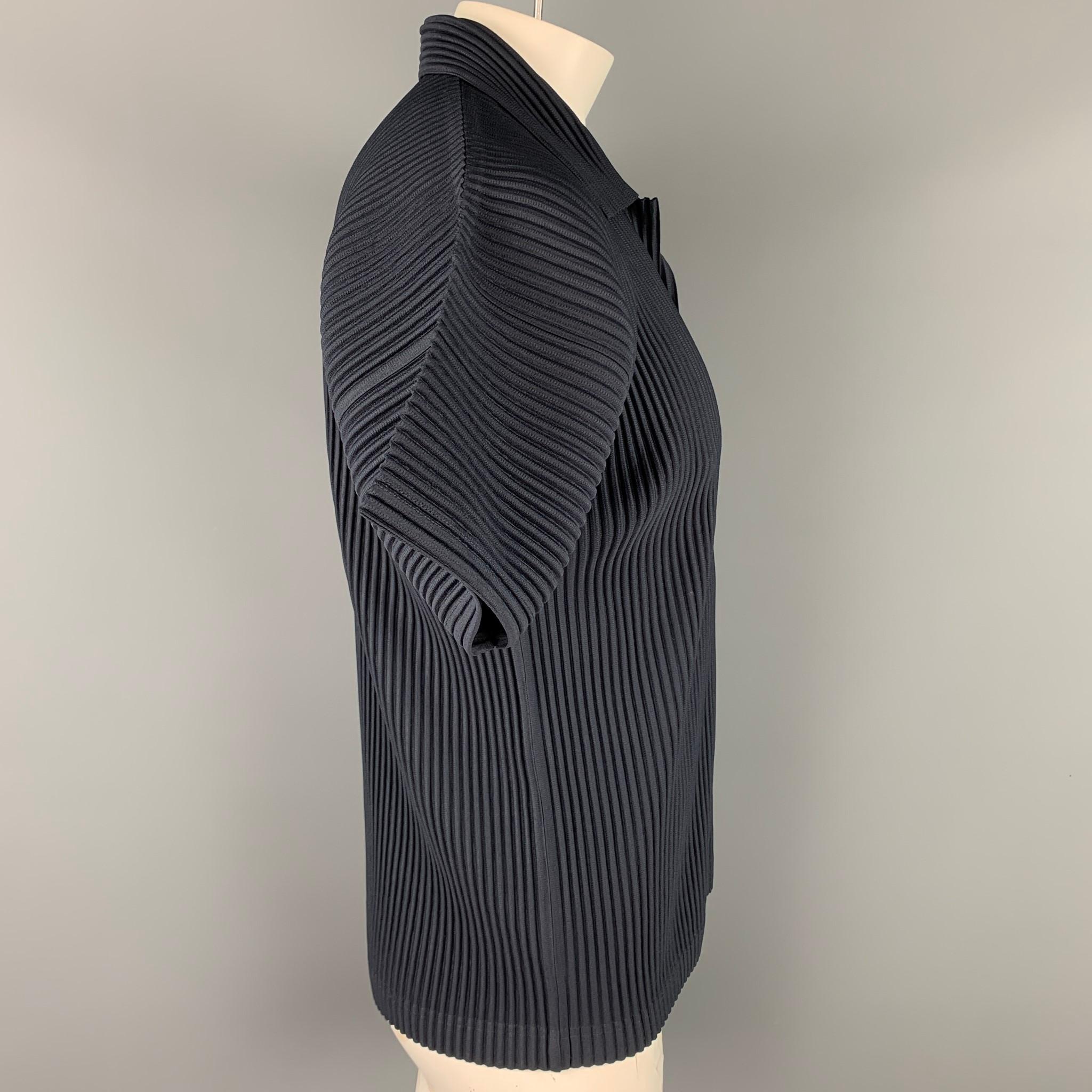 ISSEY MIYAKE Homme Plisse polo comes in a navy pleated polyester featuring a v-neck and a spread collar.

New With Tags. 
Marked: 4

Measurements:

Shoulder: 23 in.
Chest: 44 in.
Sleeve: 7.5 in.
Length: 26.5 in.