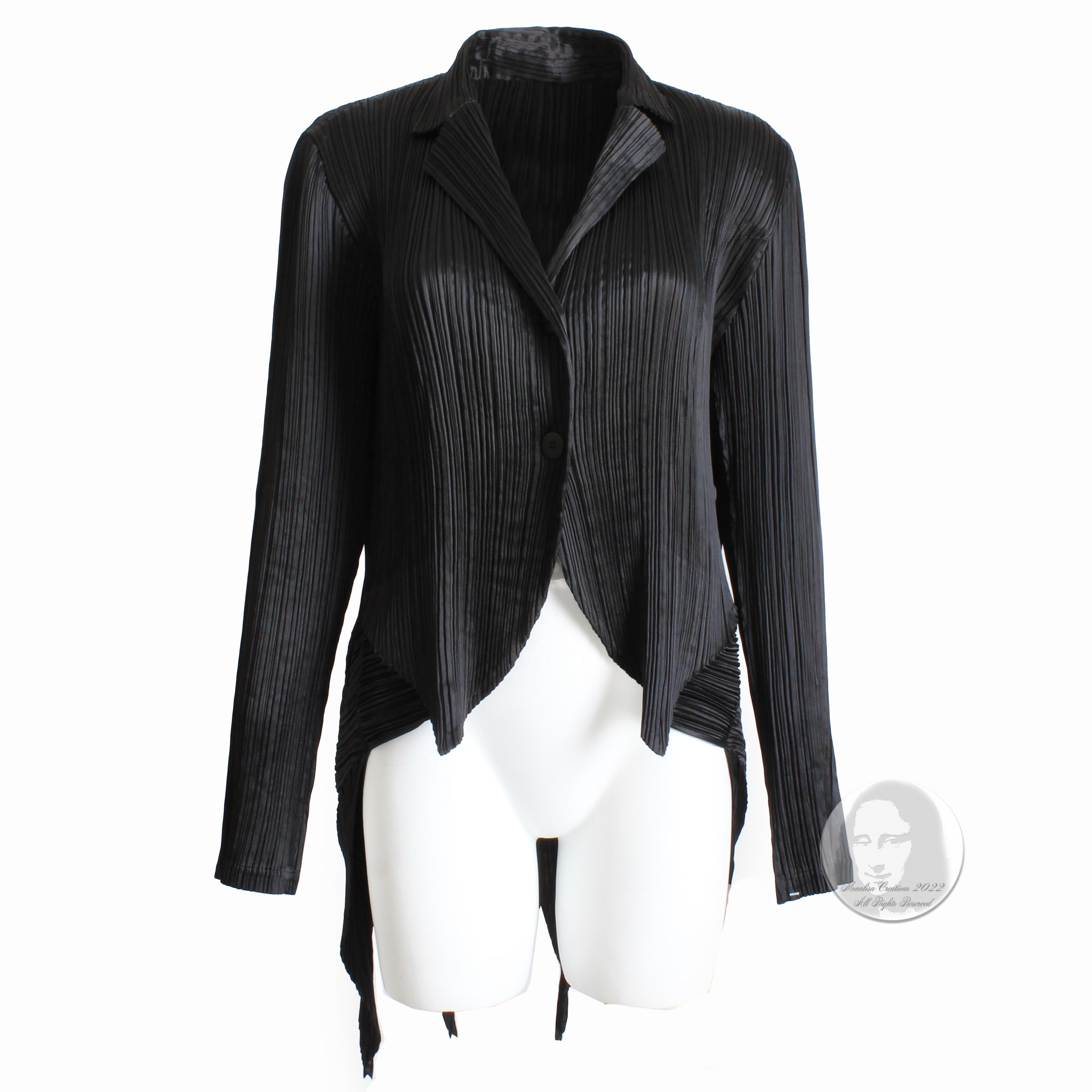 Black architecturally pleated jacket with pointed hem tails, made by the late, great Issey Miyake, most likely in the late 90s.  Made from black pleated polyester, the panels are architecturally constructed with pointed hem panels that cascade like