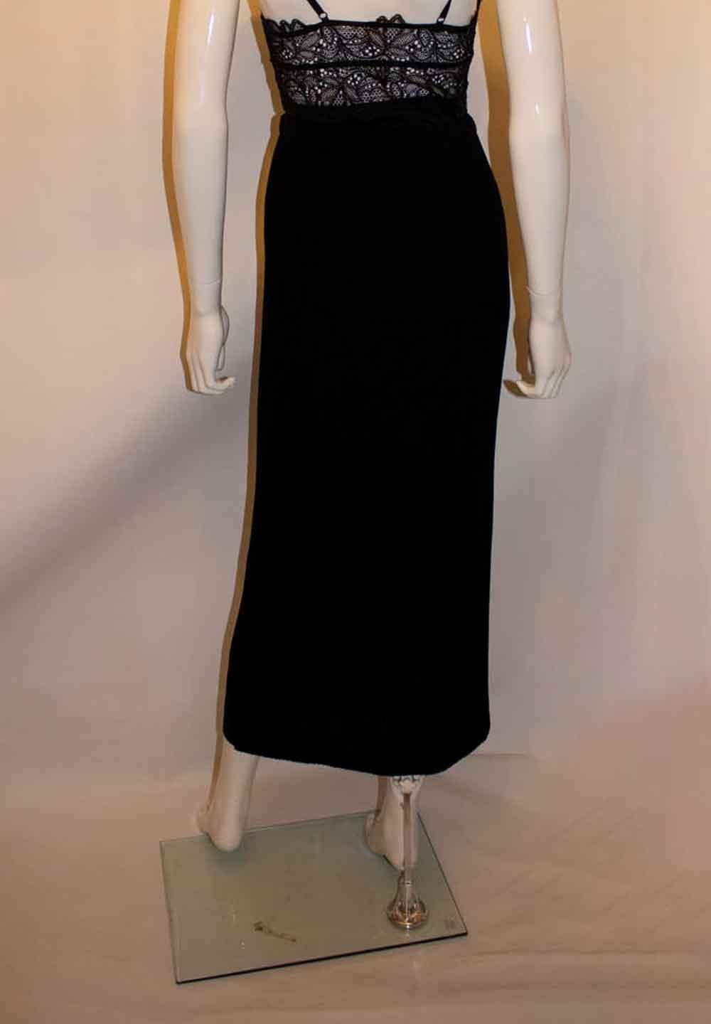 A chic and easy to wear black skirt by Issey Miyake , mainline.  Size S , model IM77 FG 601, the skirt has a decorative dark vertical band on the right hand side. Measurements: waist 24'' - 30'', length 38''
