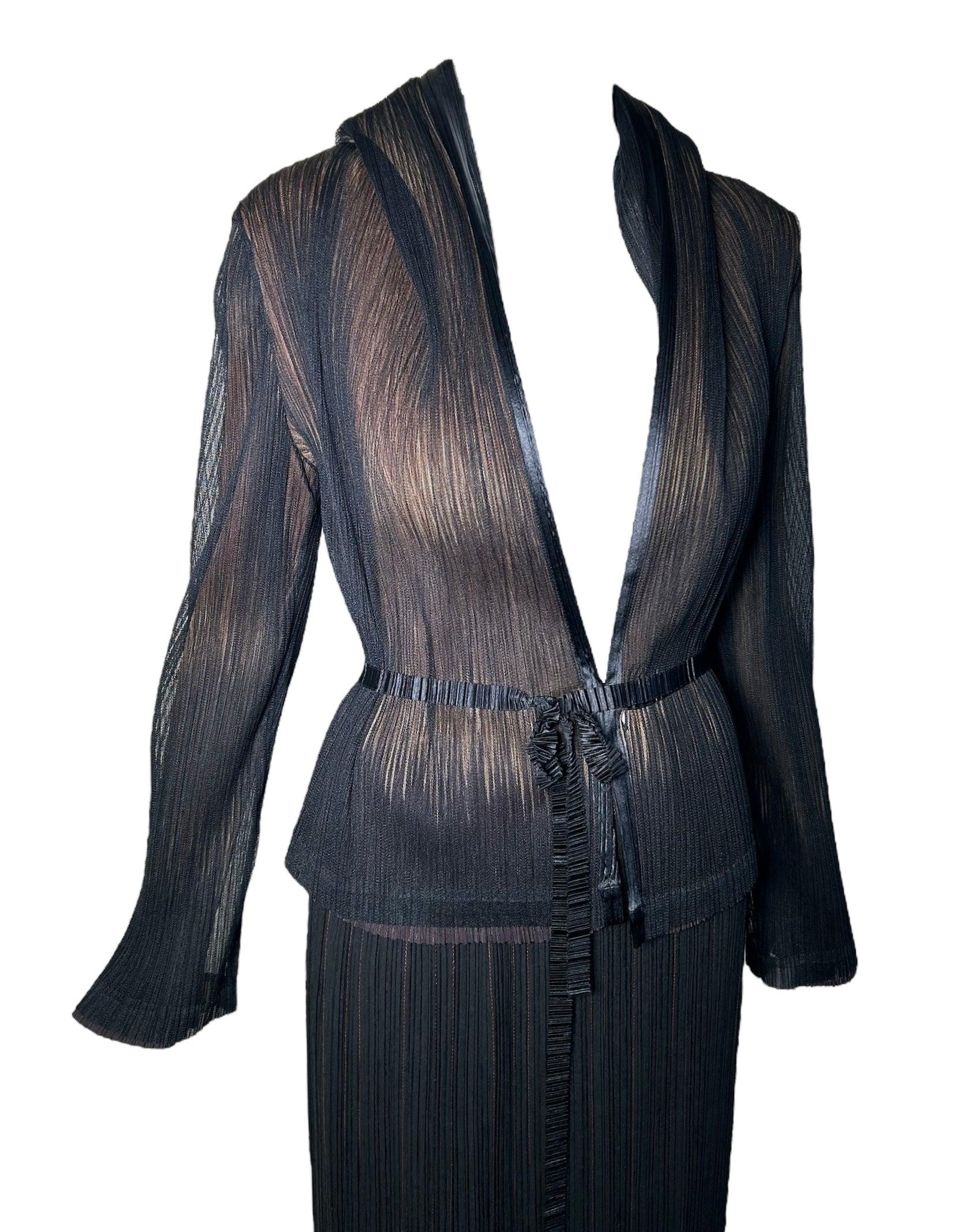 1990's Issey Miyake micro-pleated skirt and jacket ensemble. Designed by the renowned Japanese designer, this slinky jacket and skirt set features delicate micro pleats and a luxe silk waist tie. The beige and brown reflective interior adds a touch