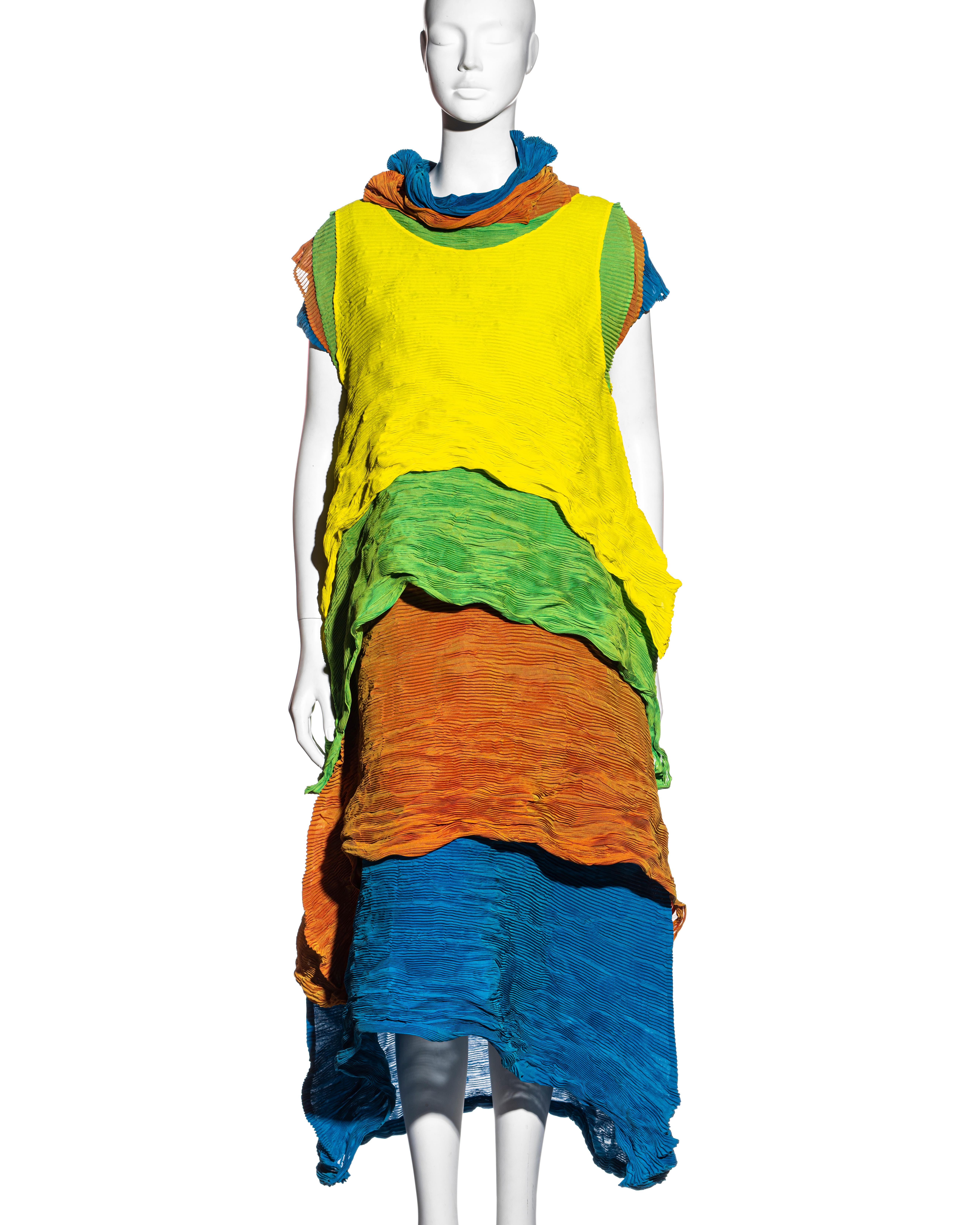 ▪ Issey Miyake rare layered pleated dress
▪ Consisting of four-layered individual garments
▪ A-line shape 
▪ Designed to bounce up and down when worn 
▪ Yellow, green, orange, and blue
▪ 100% polyester 
▪ Size Medium
▪ Spring-Summer 1993