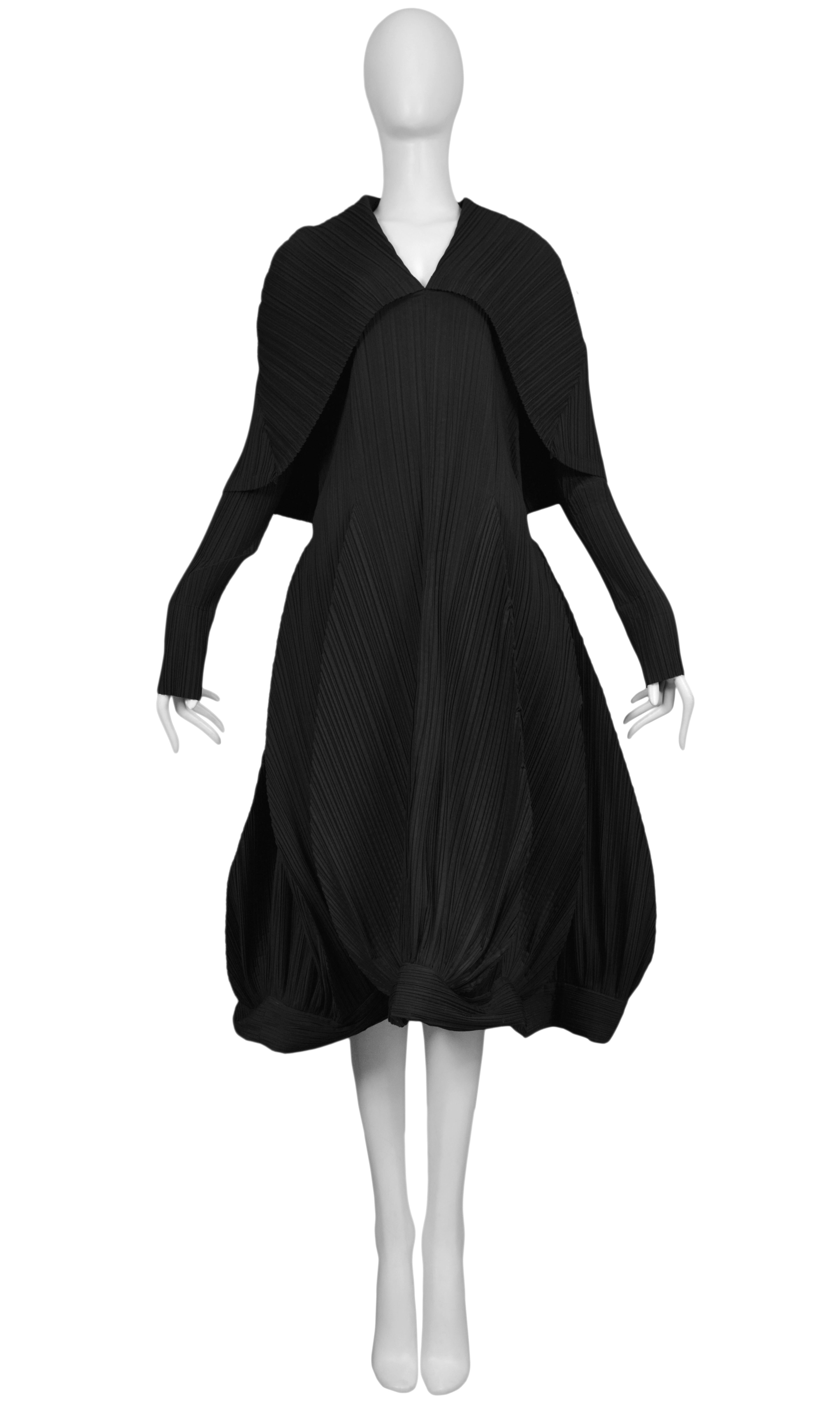 Vintage Issey Miyake black pleated dress from 1985 collection. Collar can be worn down as shown or as a hood. Similar versions were later seen in Miyake's 1990 collection. A rare and unusual example that is featured in The Metropolitan Museum's