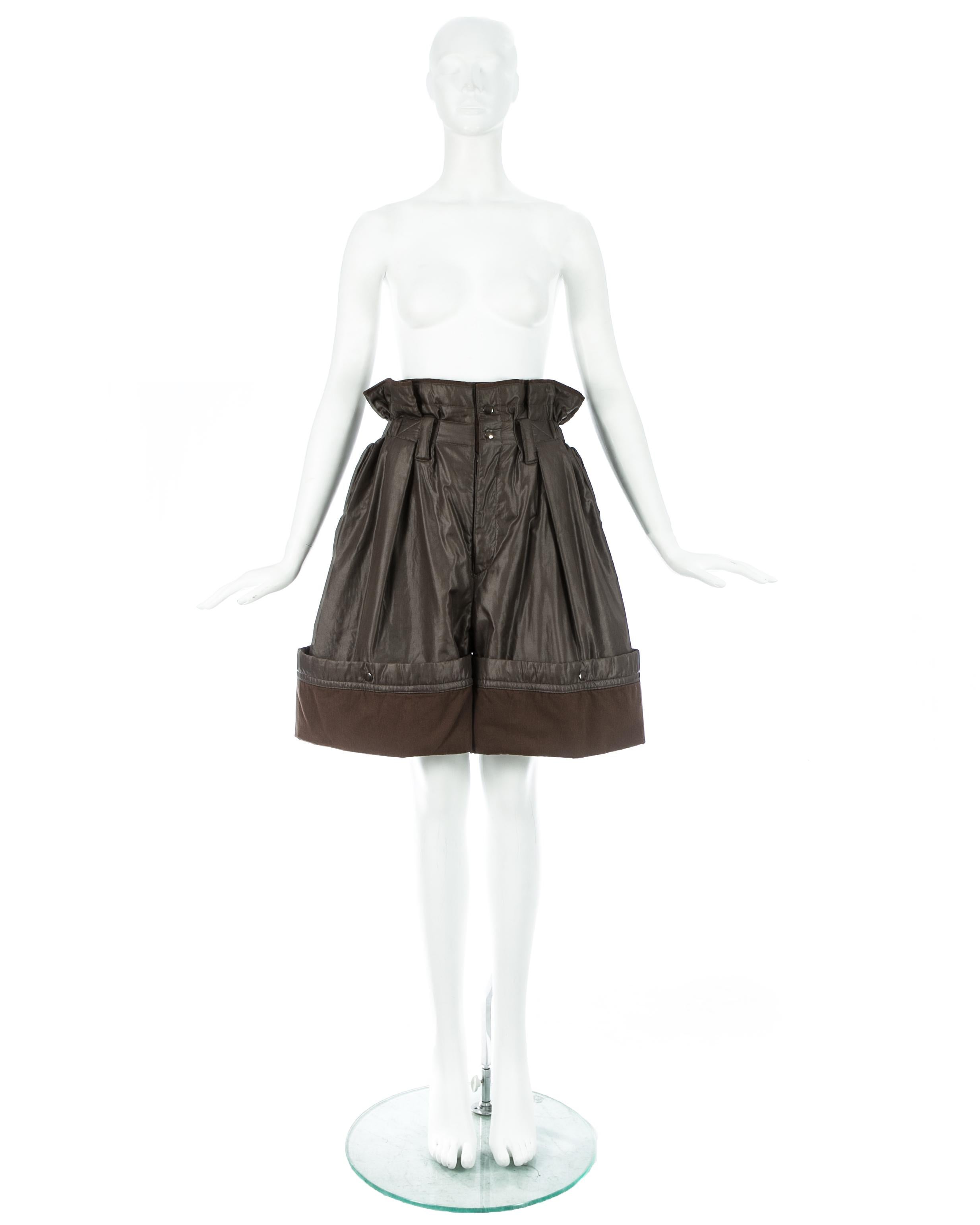 Issey Miyake; olive nylon oversized parachute shorts with paper bag elastic waistband, 2 front pockets and snap button fastenings around hem, allowing the shorts to be turned up or let down. 

Fall-Winter 1983 
