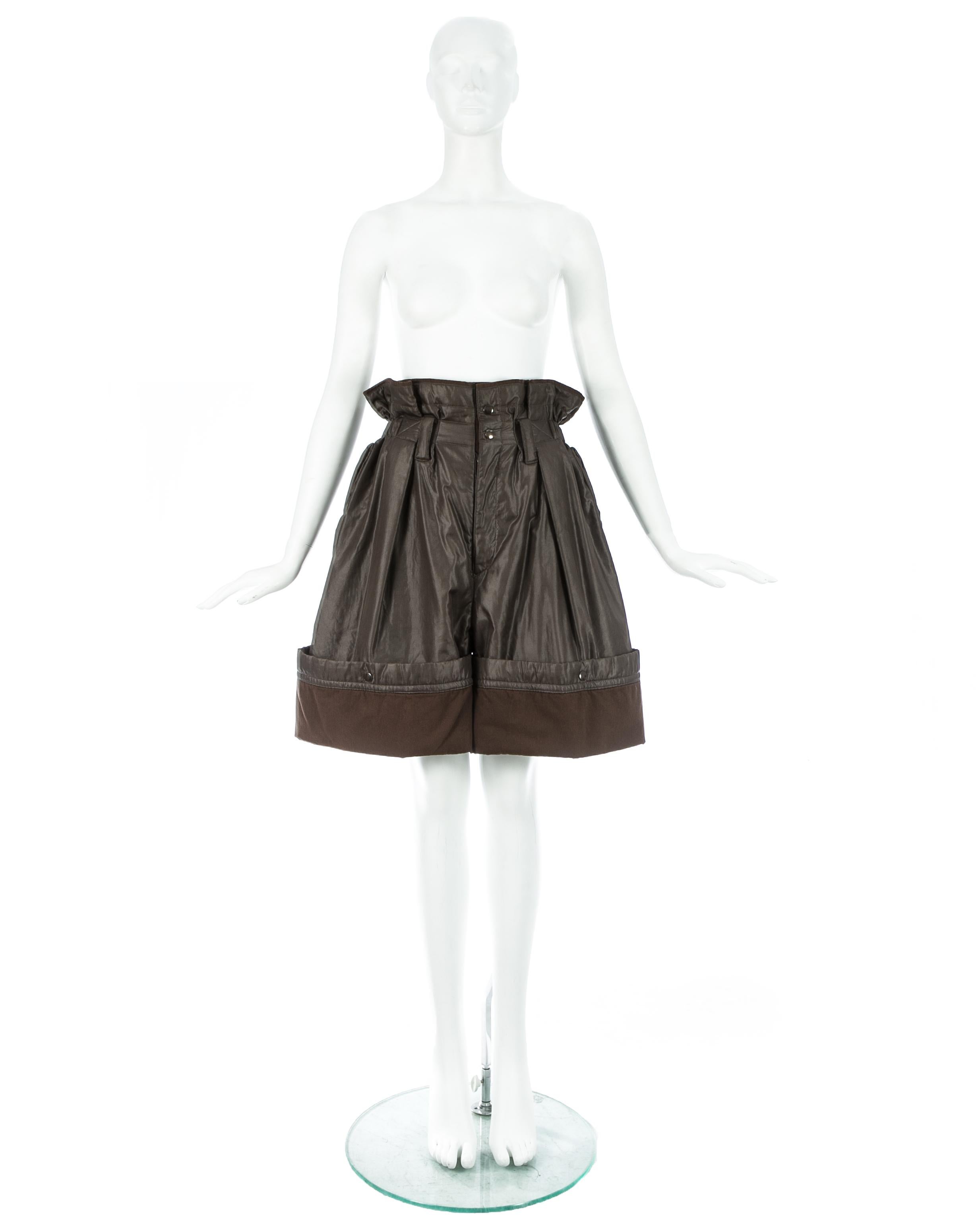 Issey Miyake; olive nylon oversized parachute shorts with paper bag elastic waistband, 2 front pockets and snap button fastenings around hem, allowing the shorts to be turned up or let down.

Fall-Winter 1983