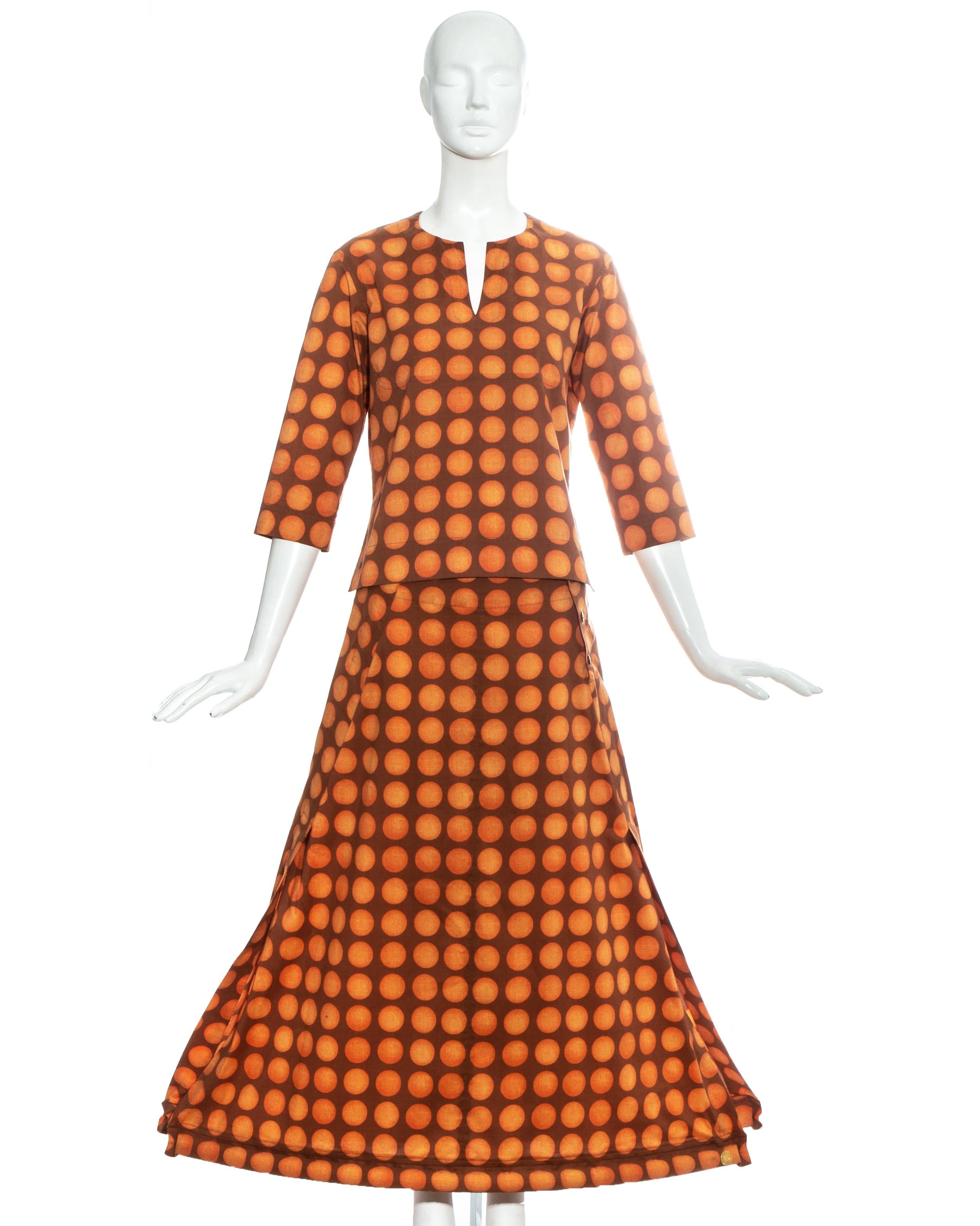 Issey Miyake orange polkadot printed cotton skirt suit comprising: tunic with three-quarter length sleeves and maxi skirt with inflatable tubular hem.

Spring-Summer 2001