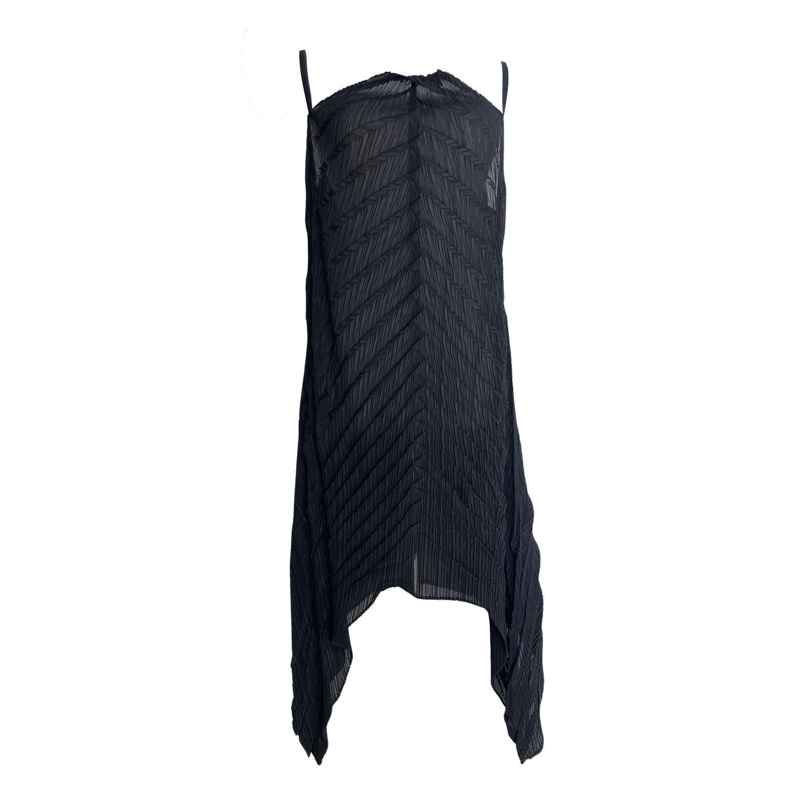 Issey Miyake pleated A line black top from circa 1990's. 
The signature pleating creates a dynamic texture and flattering silhouette,  great layering piece. 
Fits like size Medium. 

Measurements:
Center front length : 68 cm
