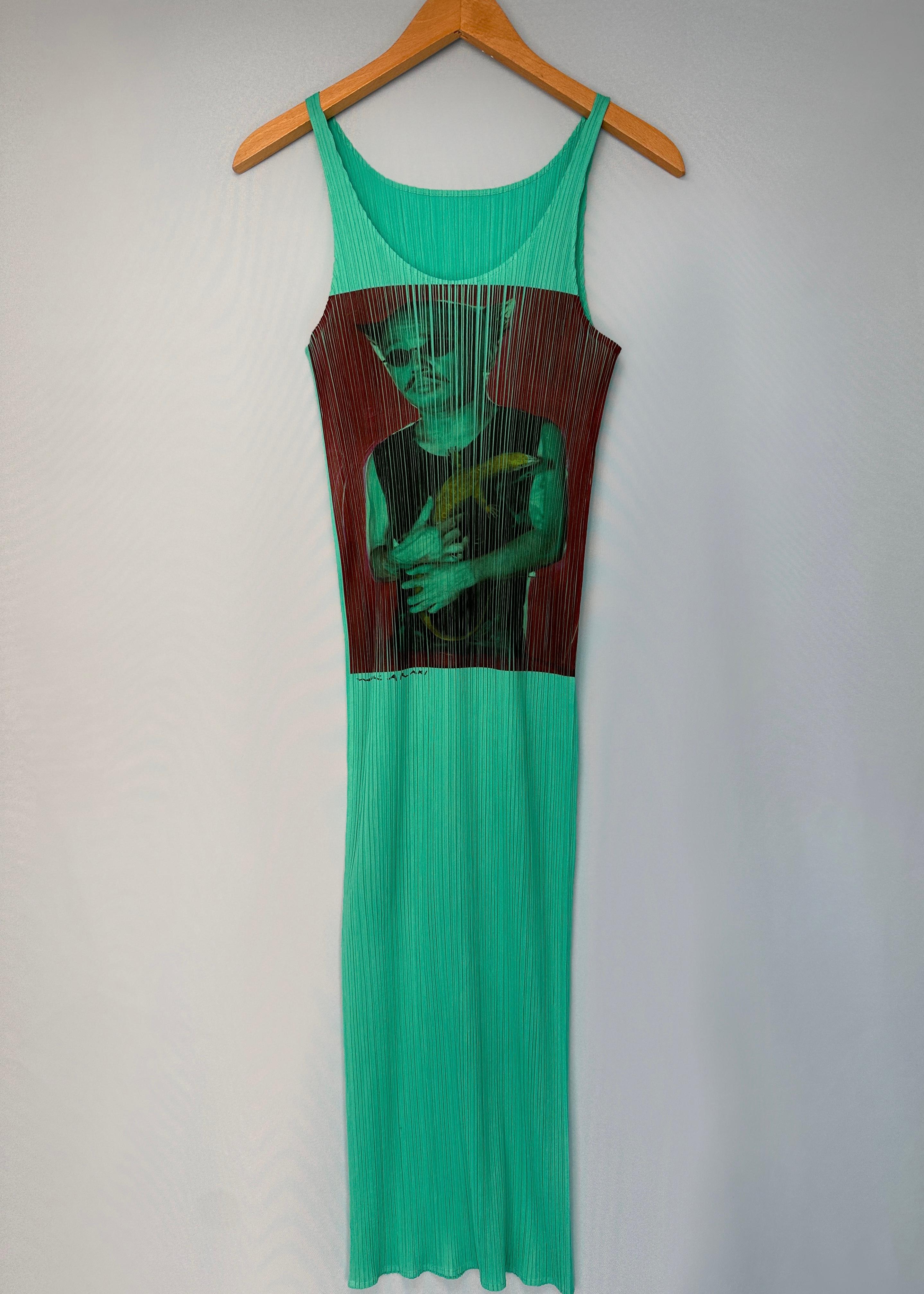 Vintage Issey Miyake Pleats Please
1997
Guest Series No. 2 - Nobuyoshi Araki

Turquoise pleated dress with printed design of Araki himself

Size 