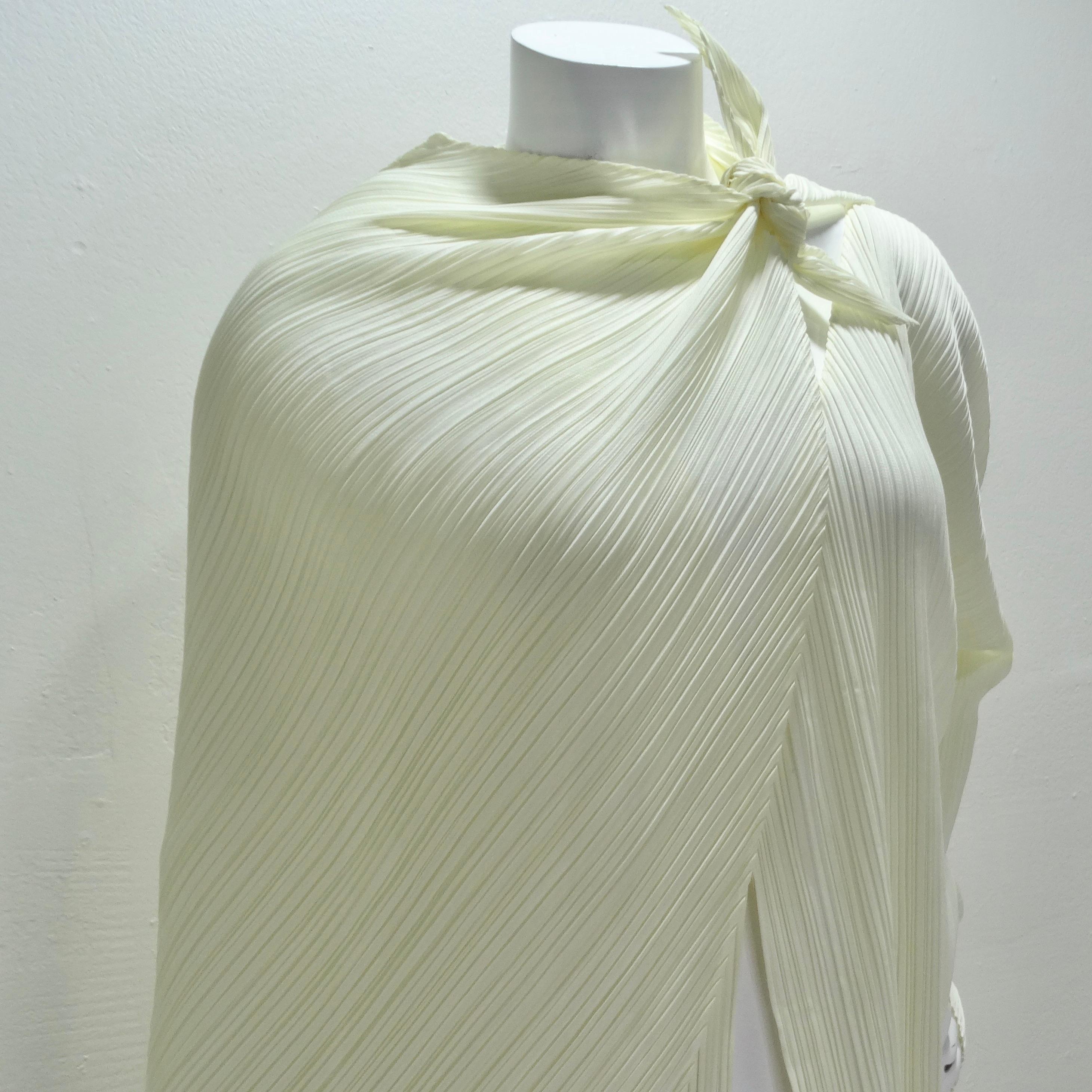 Step into the world of iconic fashion with the Issey Miyake Pleats Please cardigan and shawl set from the 1990s. Crafted in a mesmerizing off-white hue, this set showcases Issey Miyake's signature pleated fabric that gracefully molds to the wearer's