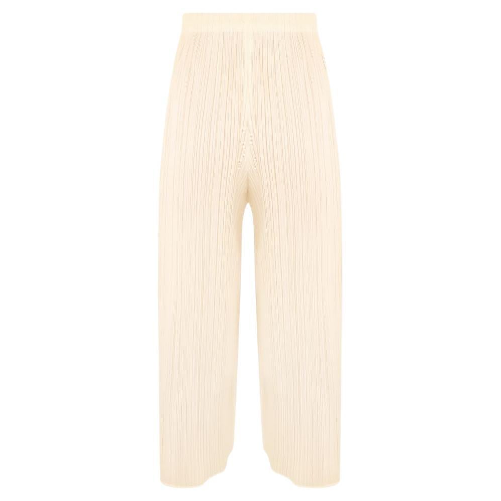 Issey Miyake Pleats Please cream colored pants with elastic waistband.

Classic micro-pleats. 

Semi-sheer.

Straight silhouette.

Condition Details: In very good, gently used condition consistent with its age and use. There are a few very