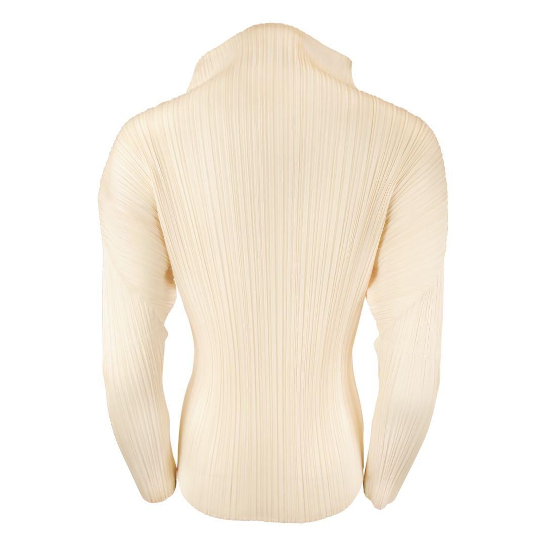 Issey Miyake Pleats Please cream colored micro pleated long sleeve top with mockneck collar.

Sits upright and has exaggerated arched shoulders.

Material has a soft sheen and is semi-sheer.

The material is very lightweight but maintains structure