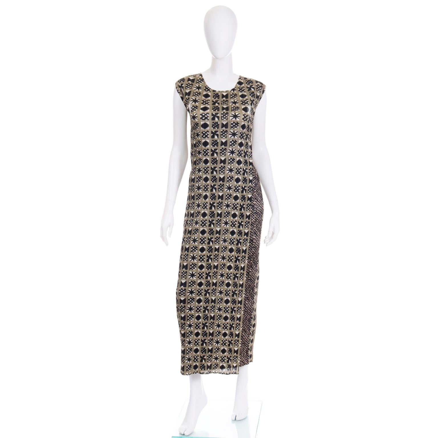 This is a fabulous Pleats Please by Issey Miyake tank dress with a very unique green, black, and white box pattern throughout. The print looks like it is a unique dye pattern that has some variation to the design. The fit of this tank dress is very