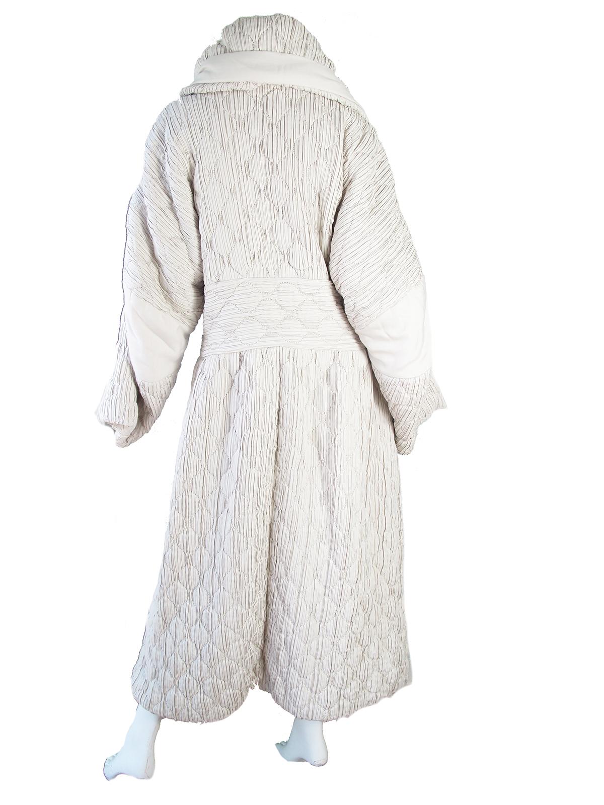 1990s Issey Miyake white quilted cocoon coat. Condition: Very good, yellow line across inside lining at tag level, possibly from hanger.  Size M ( mannequin is US size 6 )

