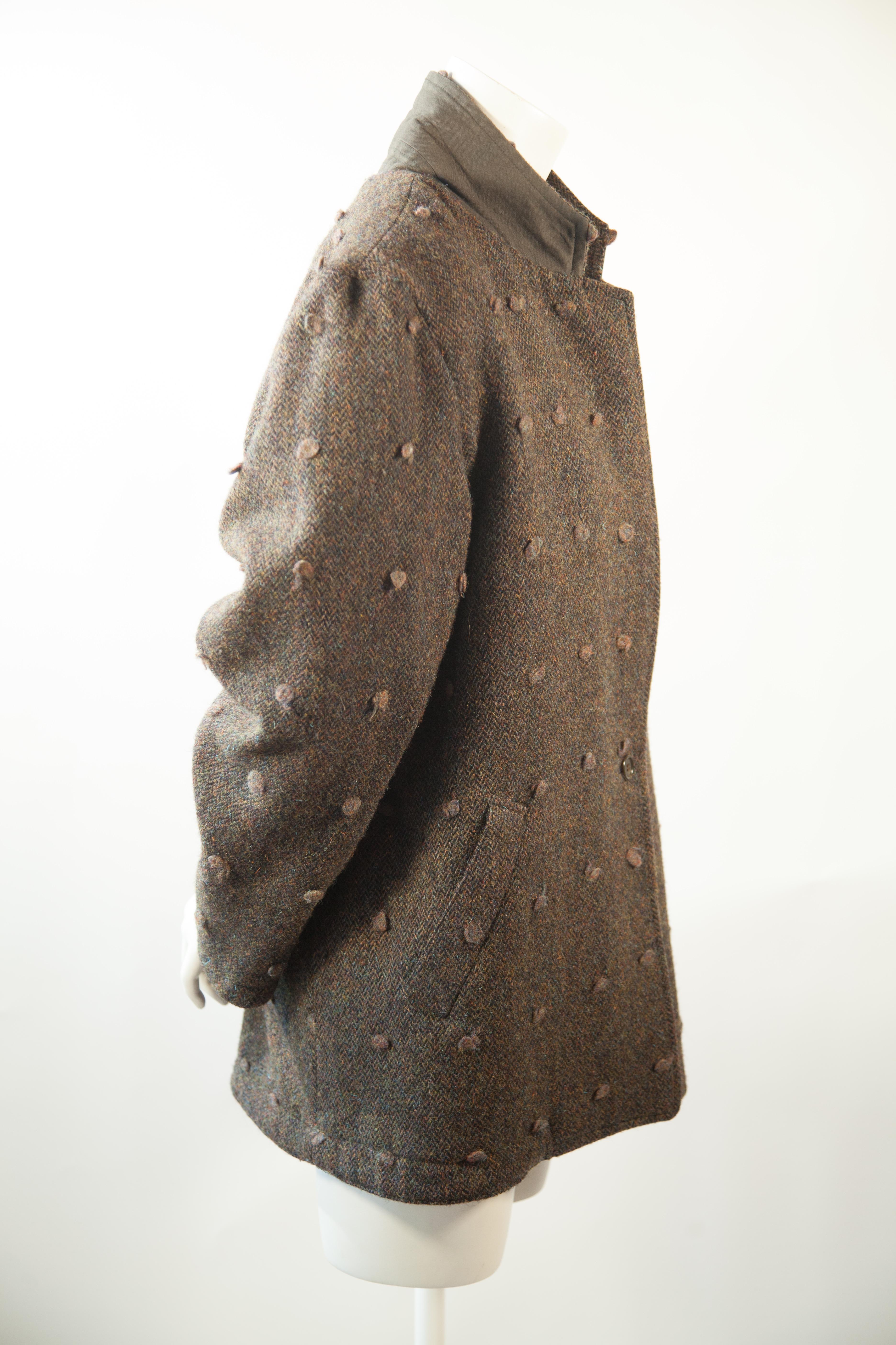 Issey Miyake, Circa 1970s
Reversible, Green, Wool, Tweed

Raised Wool Dots Pattern throughout and,

Trench Style Coat on reverse.

Issey Miyake lettering on back of collar.

Issey Miyake's innovative construction is further embellished with silk