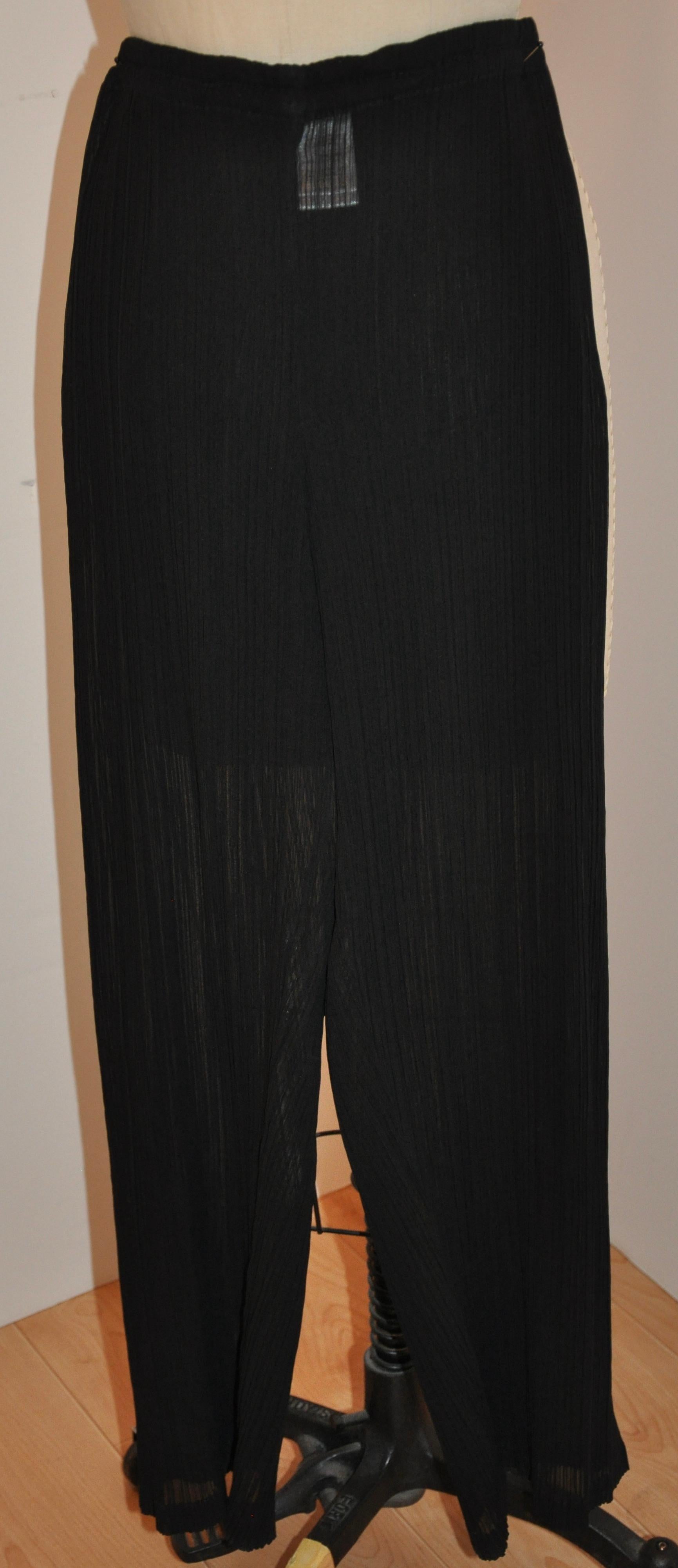        Issey Miyake signature jet-black elastic-waist wide-leg trousers measures 24 - 30 inches on the waist. Waistband is 1 inch in width, outer leg measures 38 inches, inter leg length is 28 inches, hem circumference is 18 inches. Please note: All