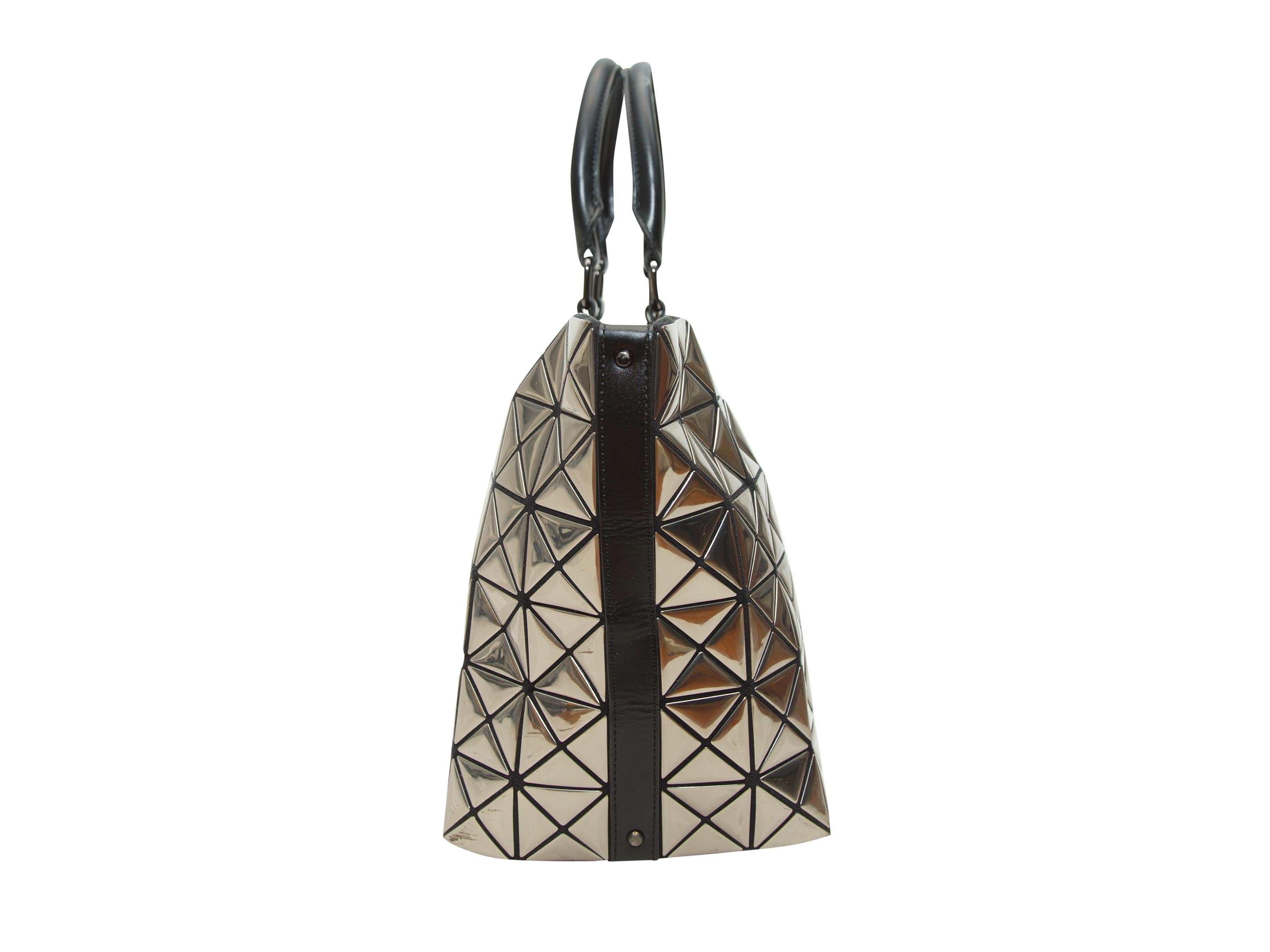 Product details: Silver metallic Bao Bao bag by Issey Miyake. Black trim. Dual top handles. 17