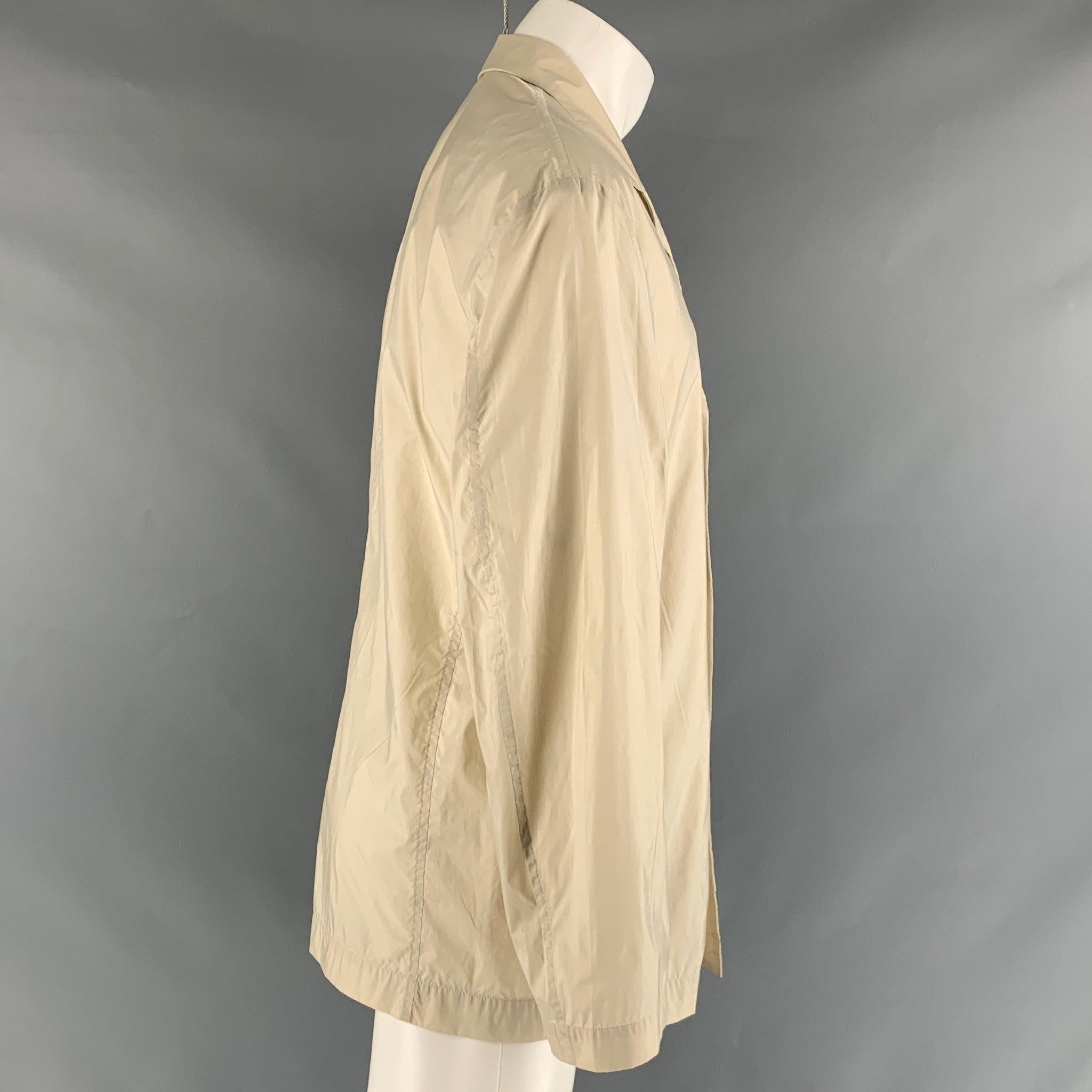 ISSEY MIYAKE jacket comes in a beige nylon woven material featuring a notch lapel, flap pockets, and a button closure. Made in Japan. Excellent Pre-Owned Condition. 

Marked:   40 

Measurements: 
 
Shoulder: 21 inches Chest: 40 inches Sleeve: 24