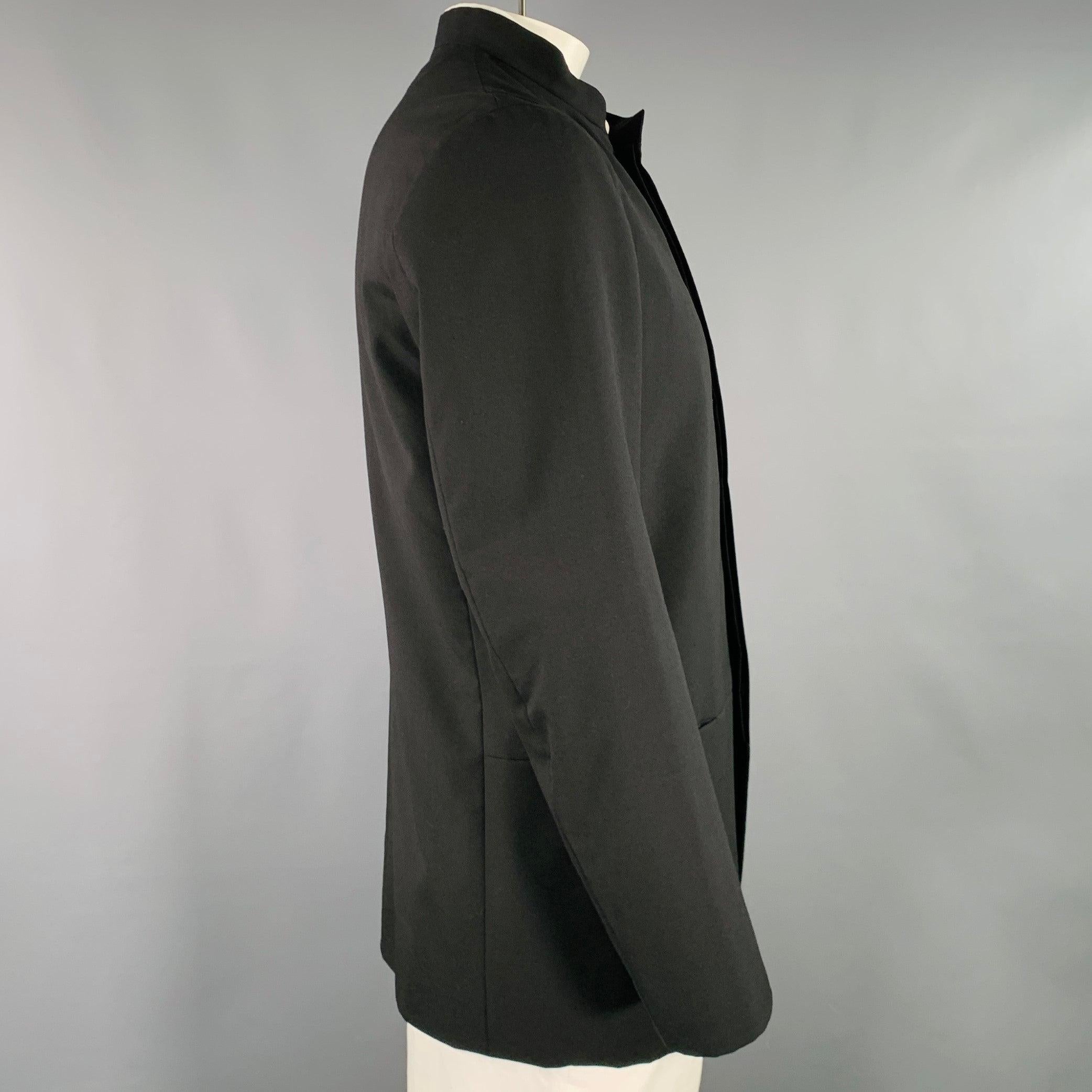 ISSEY MIYAKE sport coat
in a black wool fabric featuring a Nehru collar, ventless back, and hidden button closure. Made in Japan.Excellent Pre-Owned Condition. 

Marked:   JP 3 

Measurements: 
 
Shoulder: 19 inches Chest: 42 inches Sleeve: 24.5