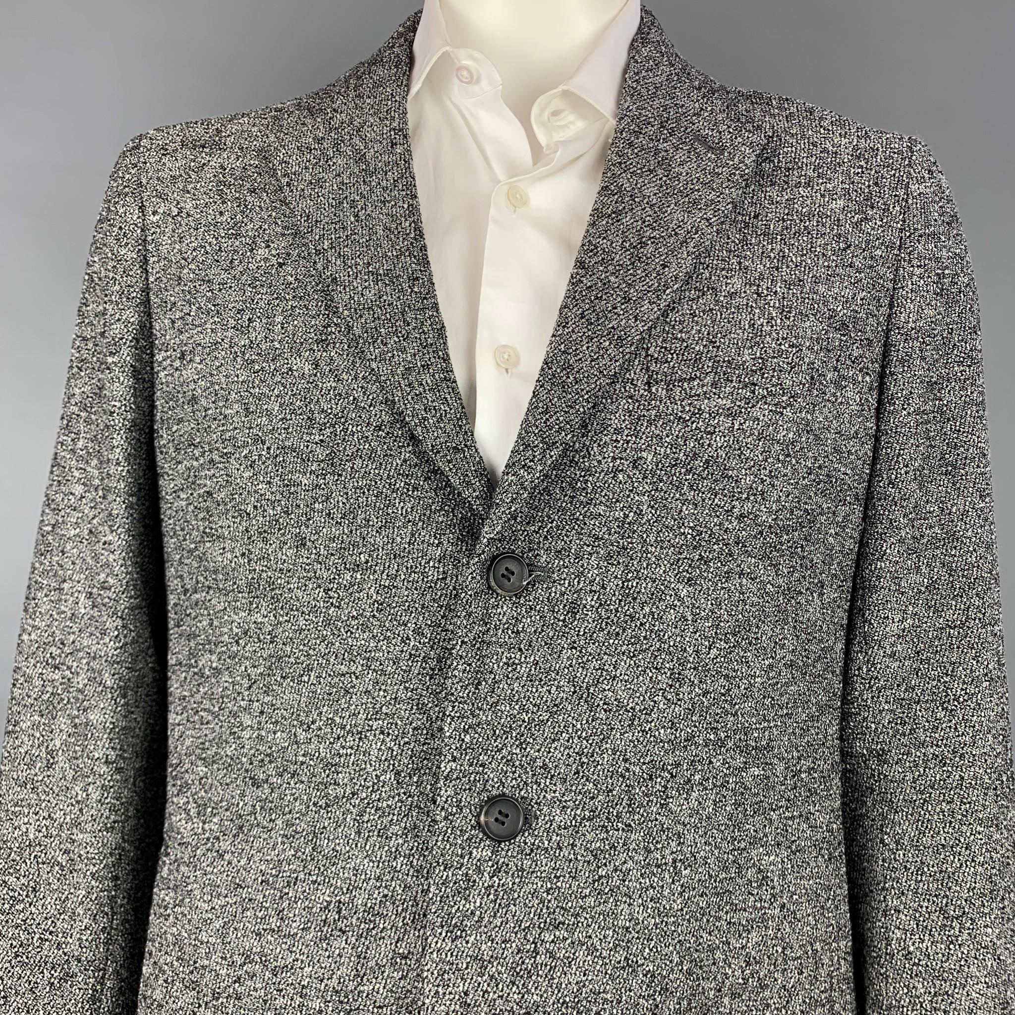 ISSEY MIYAKE sport coat comes in a black & white textured material with a full liner featuring a notch lapel, slit pockets, and a three button closure.

Very Good Pre-Owned Condition.
Marked: 3

Measurements:

Shoulder: 18 in.
Chest: 44 in.
Sleeve: