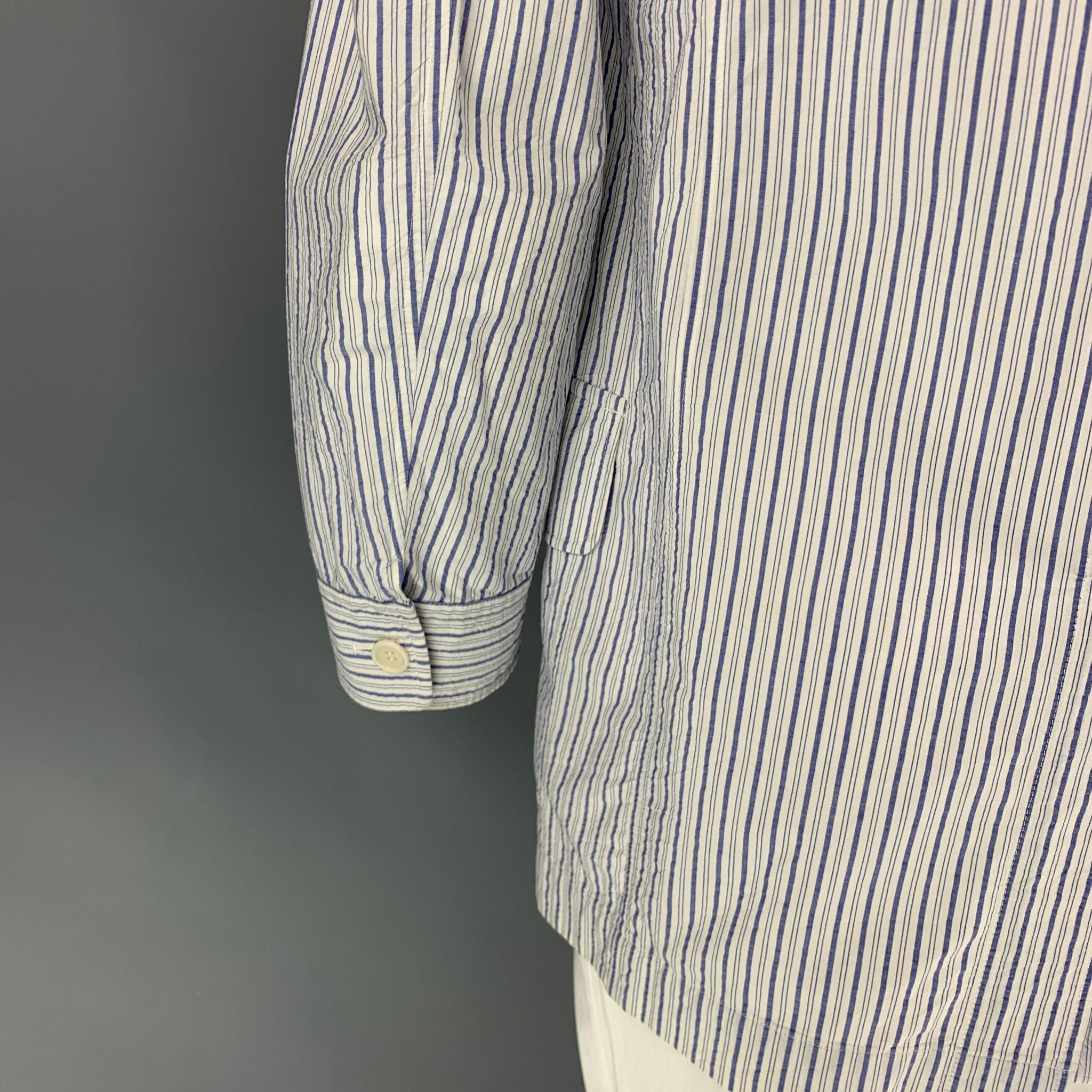 ISSEY MIYAKE sport coat comes in a white & blue stripe cotton featuring a notch lapel, patch pockets, and a three button closure. Made in Japan.

Good Pre-Owned Condition. Moderate discoloration at collar.
Marked: JP 4

Measurements:

Shoulder: 19.5