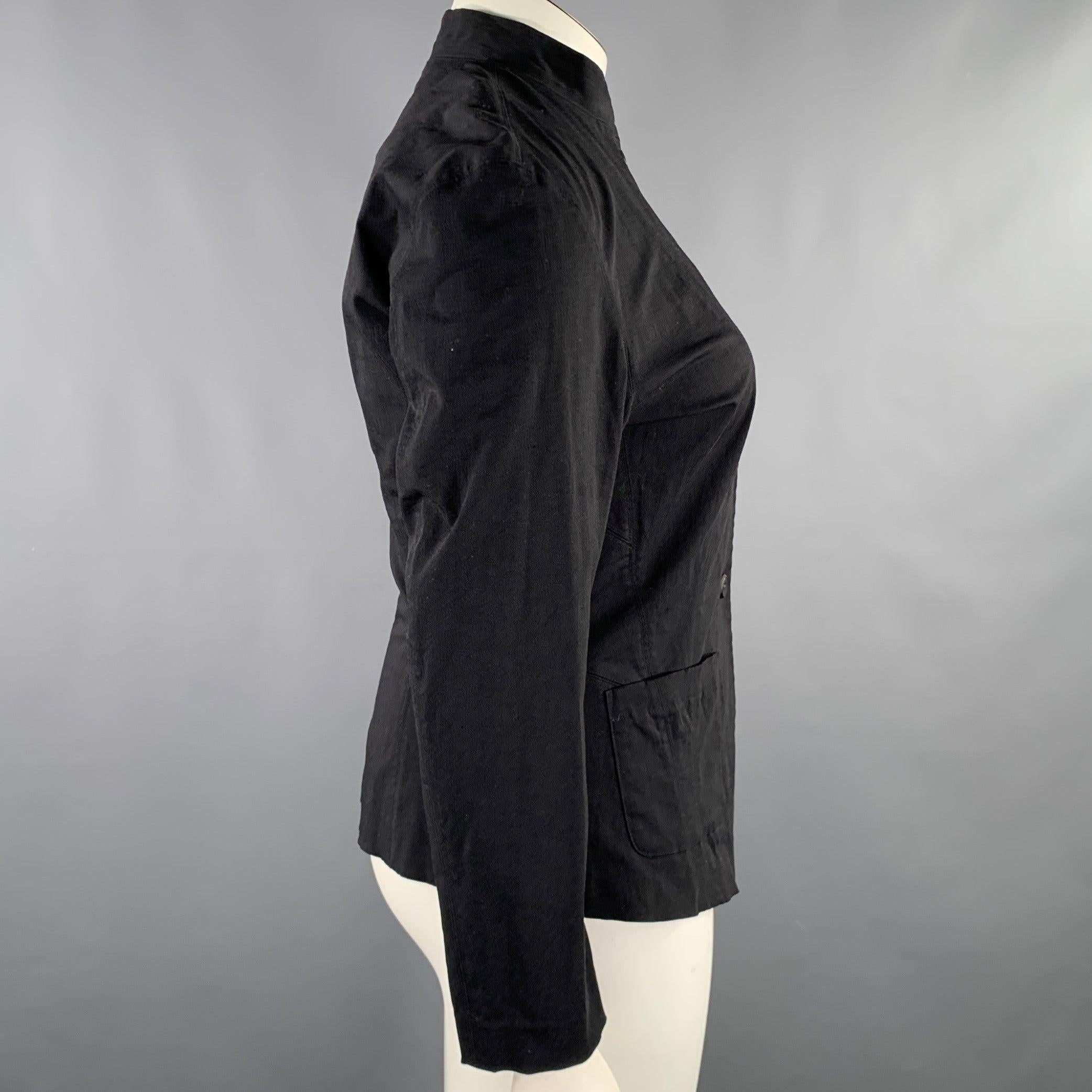 ISSEY MIYAKE jacket
in a black nylon blend fabric featuring a single breasted style, collarless design, and button closure. Made in Japan.Excellent Pre-Owned Condition. 

Marked:   L 

Measurements: 
 
Shoulder: 16 inches Bust: 34 inches Sleeve: