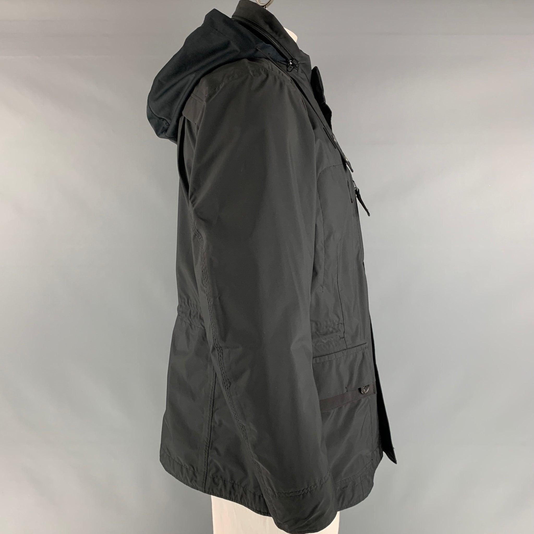 ISSEY MIYAKE jacket comes in a black polyester featuring a windbreaker style, loose fit, hooded, patch wit flap pockets, drawstring at waistband, and a zip up closure. Made in Japan.Excellent Pre-Owned Condition. 

Marked:   3 

Measurements: 
