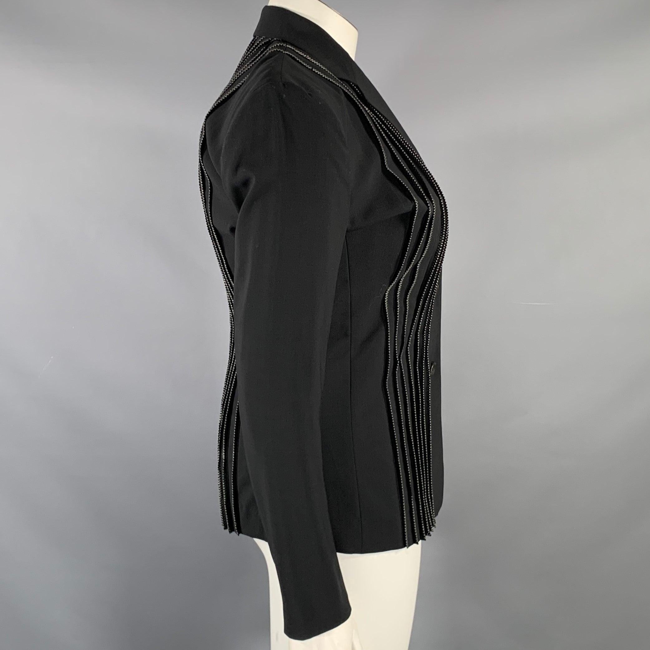 ISSEY MIYAKE blazer
in a
black wool polyester blend fabric featuring pleated front with white contrast stitching, notch lapel, and three button closure. Made in Japan.Excellent Pre-Owned Condition. 

Marked:   JP 3 

Measurements: 
 
Shoulder: 17