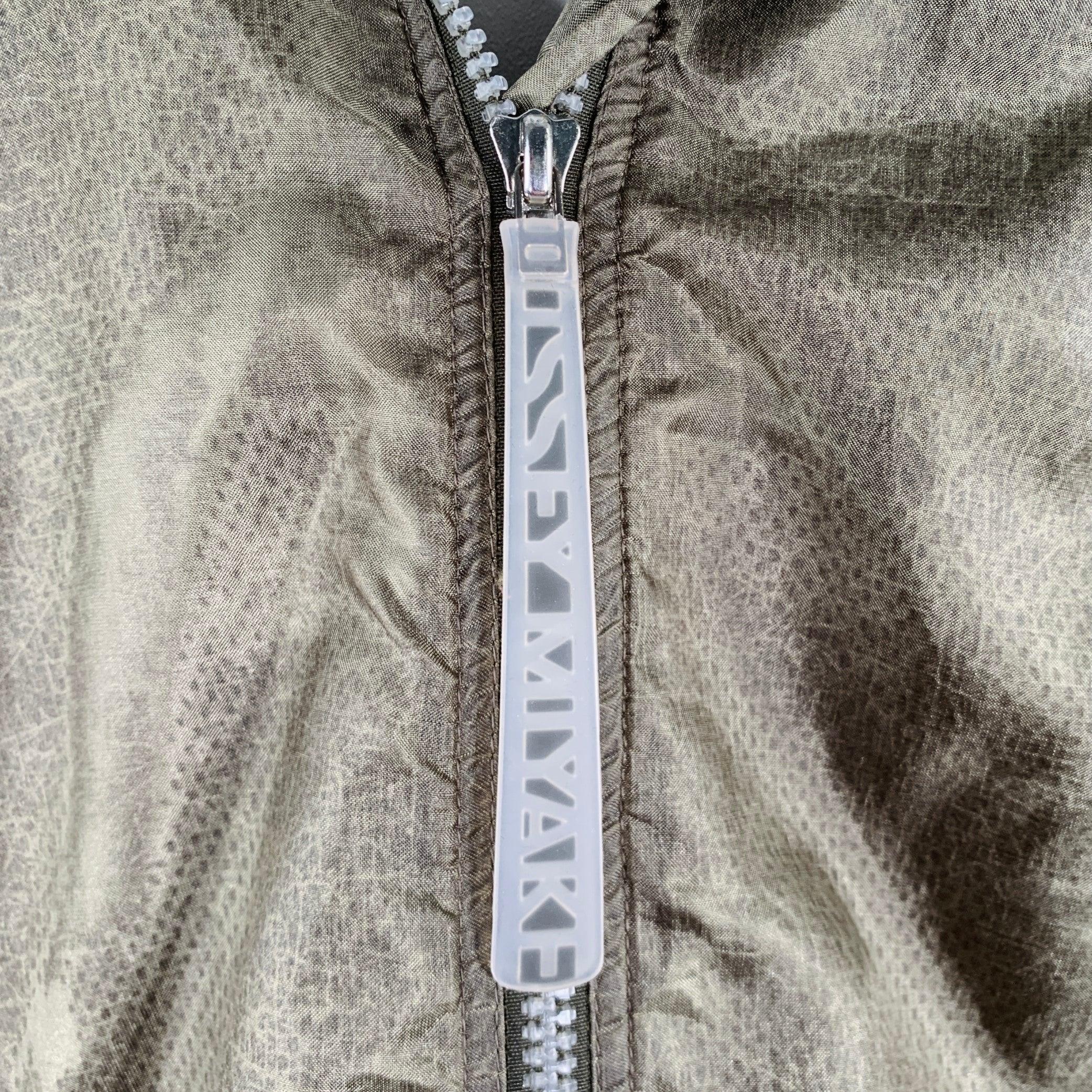 ISSEY MIYAKE jacket
in a sage green mesh fabric featuring a windbreaker style with hood, mesh lined pockets, and zip up closure. Made in Japan.Excellent Pre-Owned Condition. 

Marked:   size not marked. Tag faded. 

Measurements: 
 
Shoulder: 20