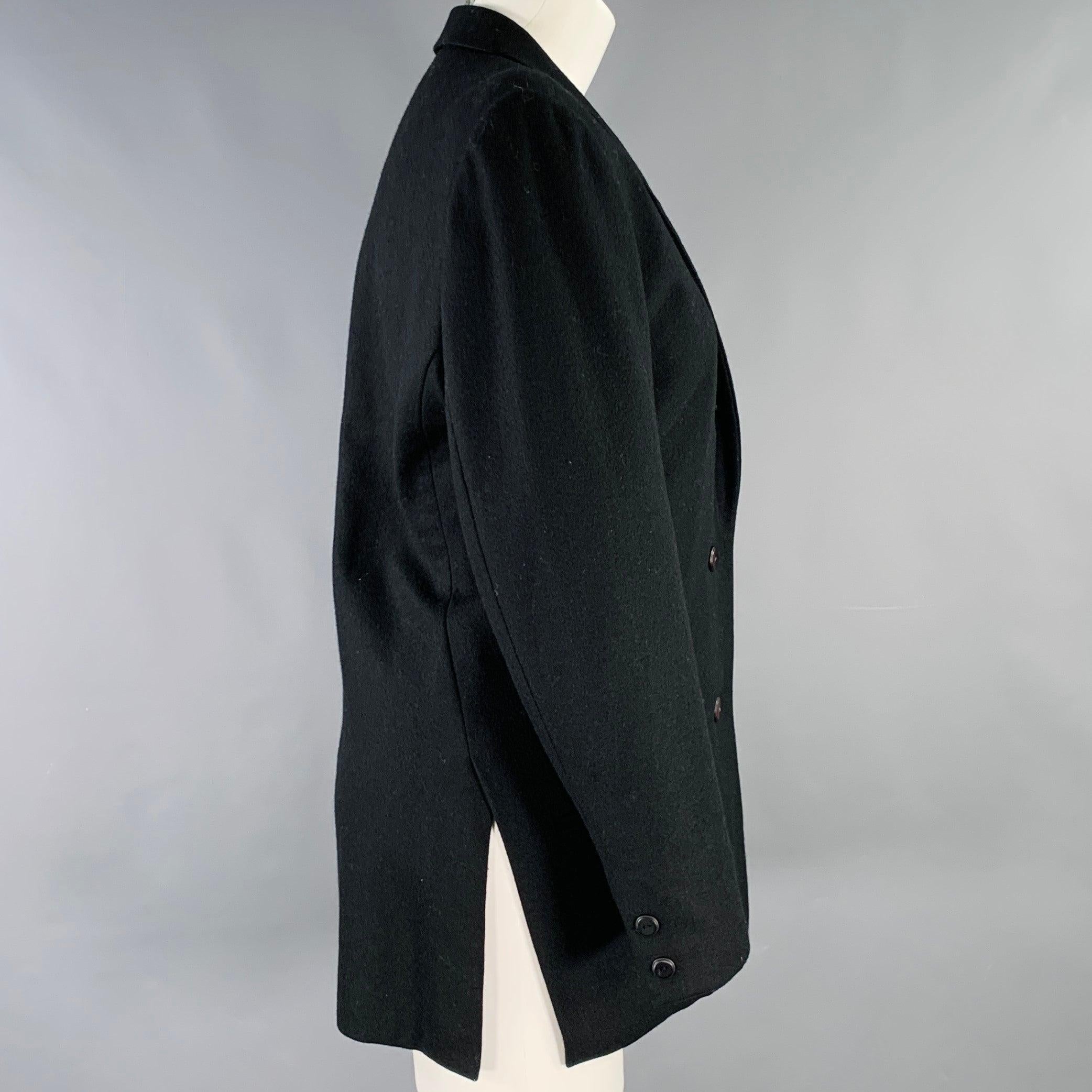 Vintage ISSEY MIYAKE blazer
in a black wool blend featuring a notch lapel, single vented back, and three button closure. Made in Japan.Excellent Pre-Owned Condition. 

Marked:   JP 9 

Measurements: 
 
Shoulder: 16.5 inches Bust: 39 inches Sleeve: